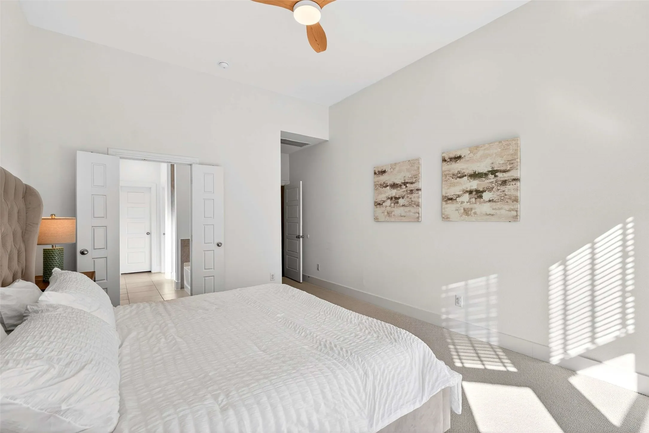 Recessed ceiling lighting, ceiling fan, carpeted flooring, and white interior doors