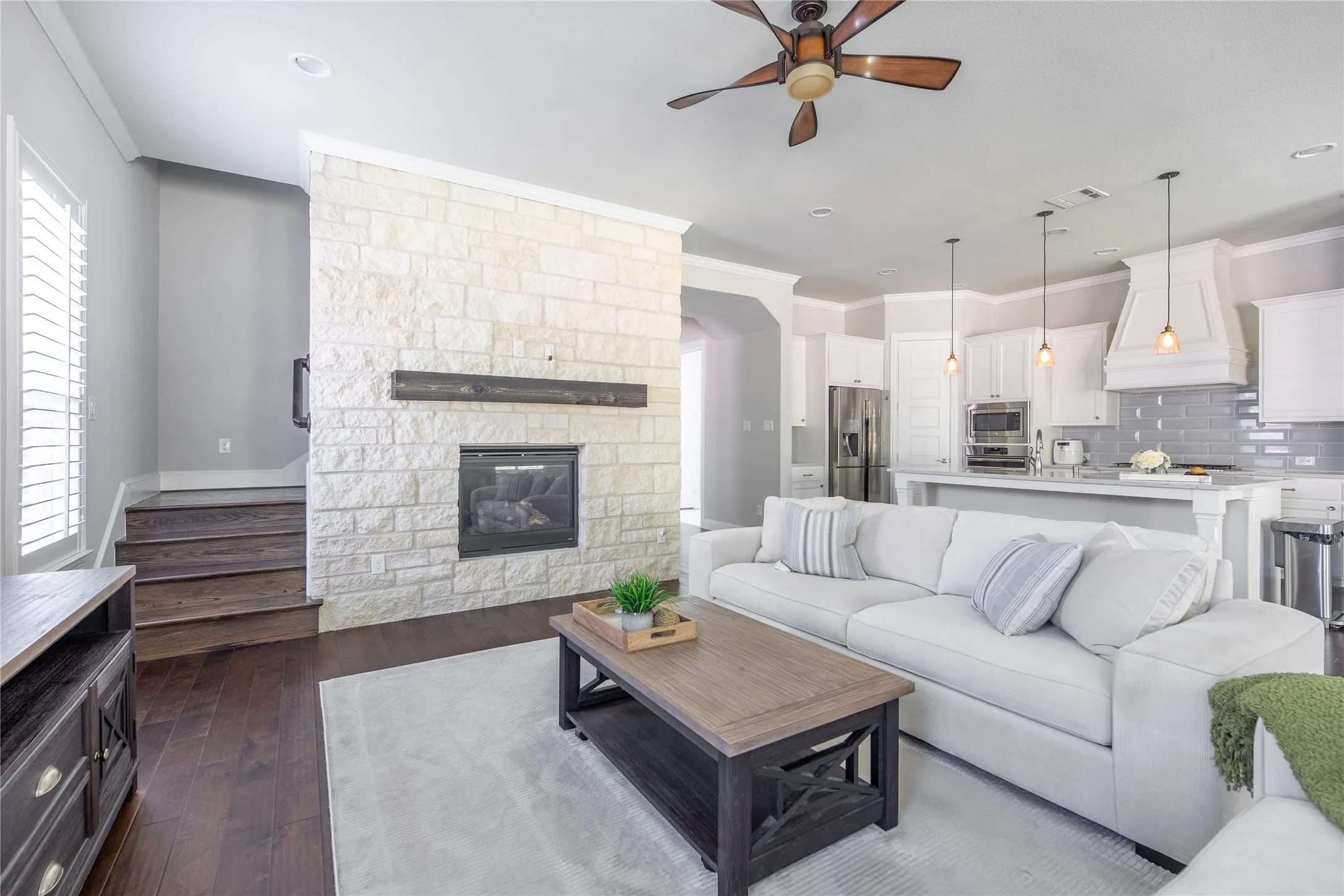 Living area with stone-clad fireplace and wood mantel