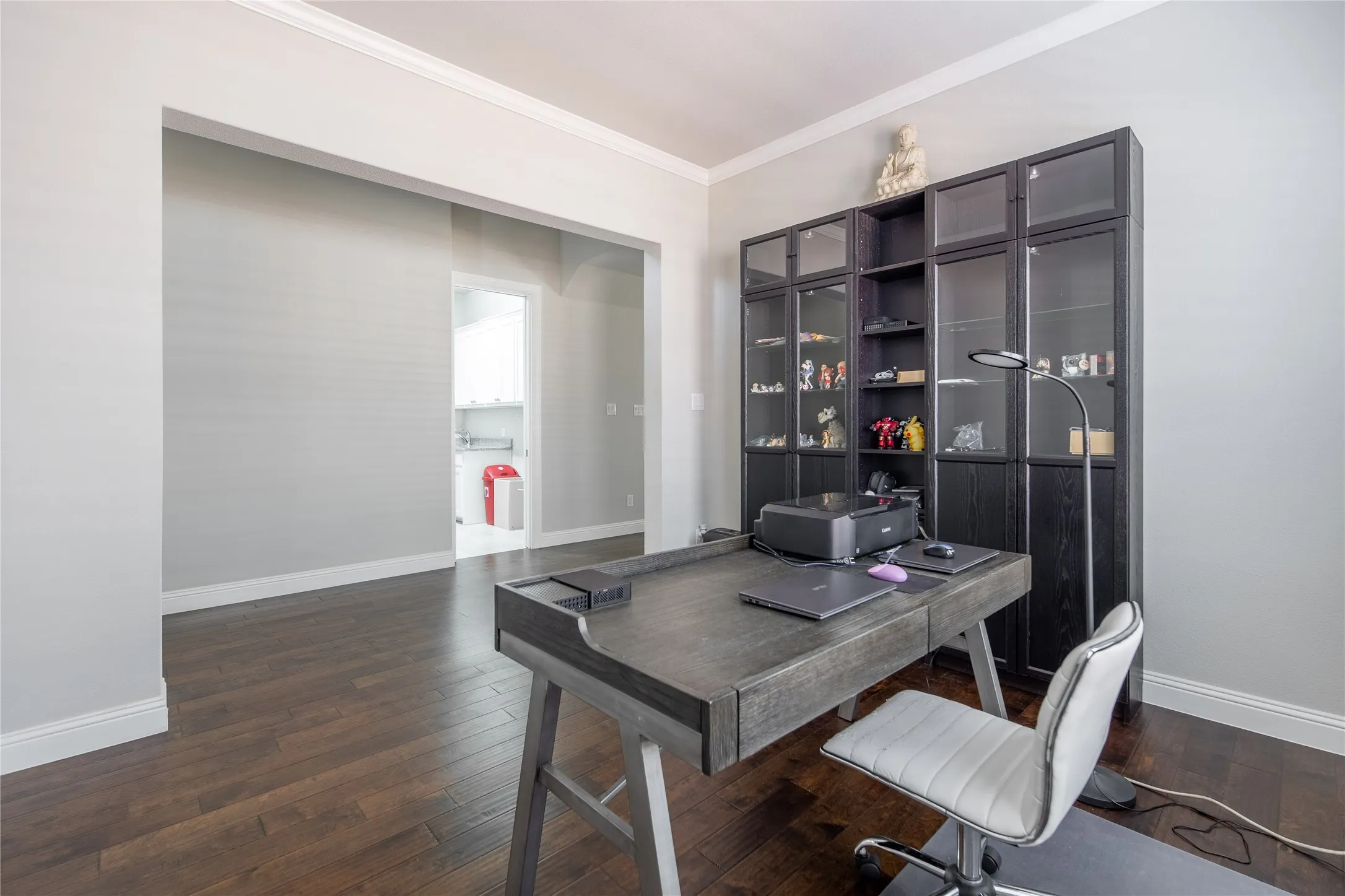 Dark wood-finish flooring with white trim