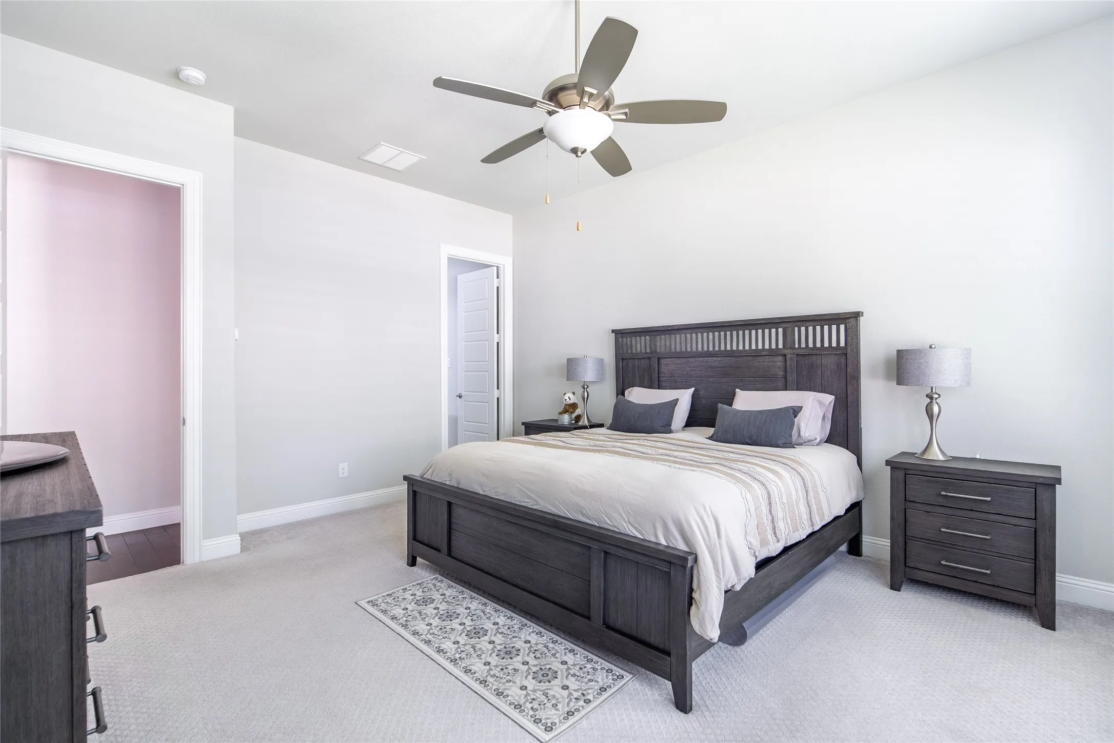 Recessed lighting, ceiling fan, and light wall tones