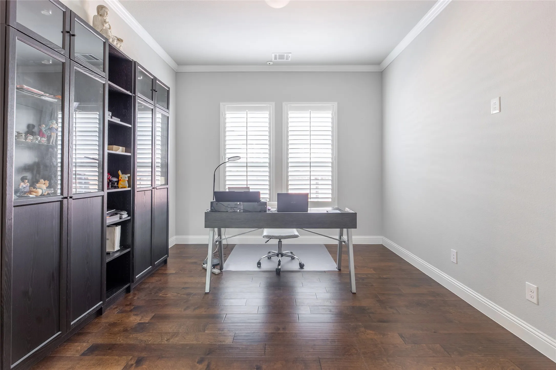 Rich wood-finish flooring complemented by white crown molding