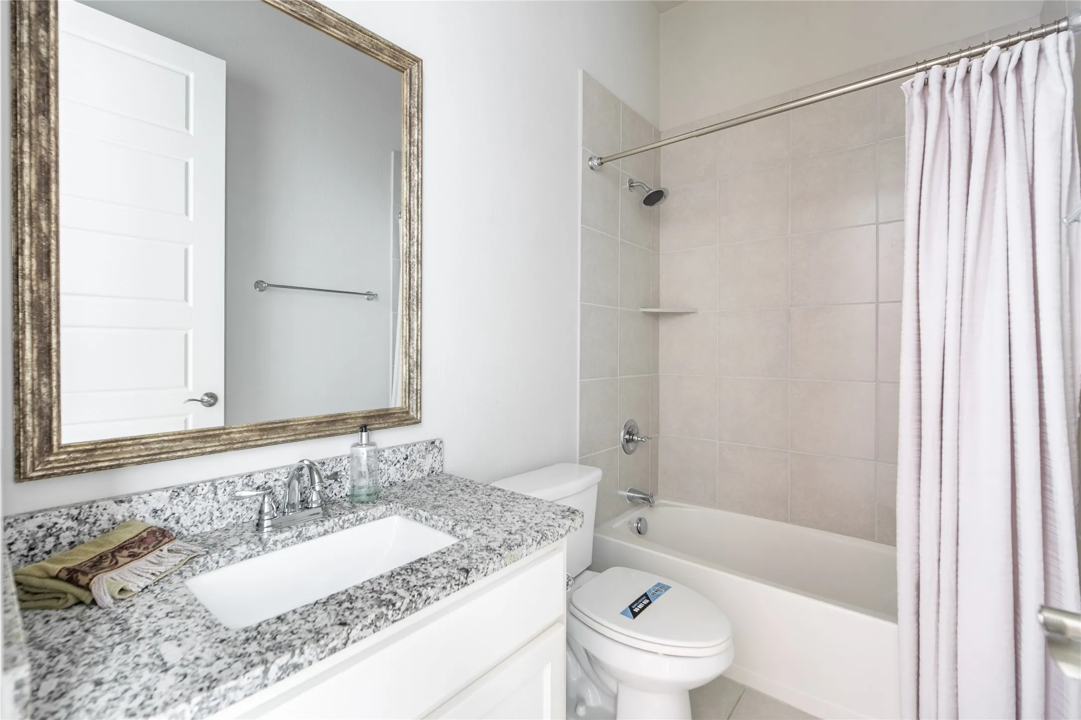 Vanity featuring a polished countertop and undermount sink