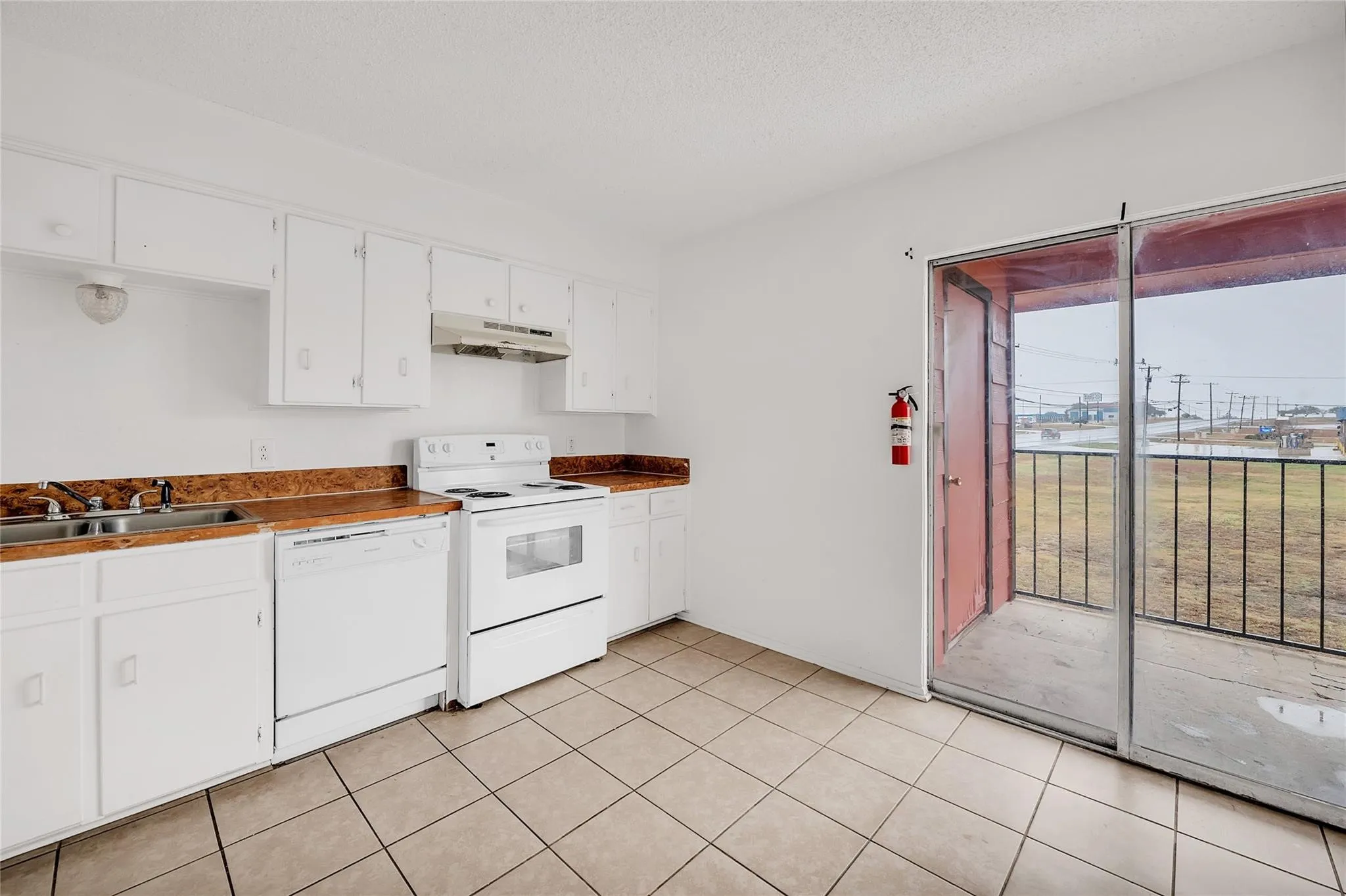Kitchen featuring white cabinetry, a white electric range, and a white dishwasher