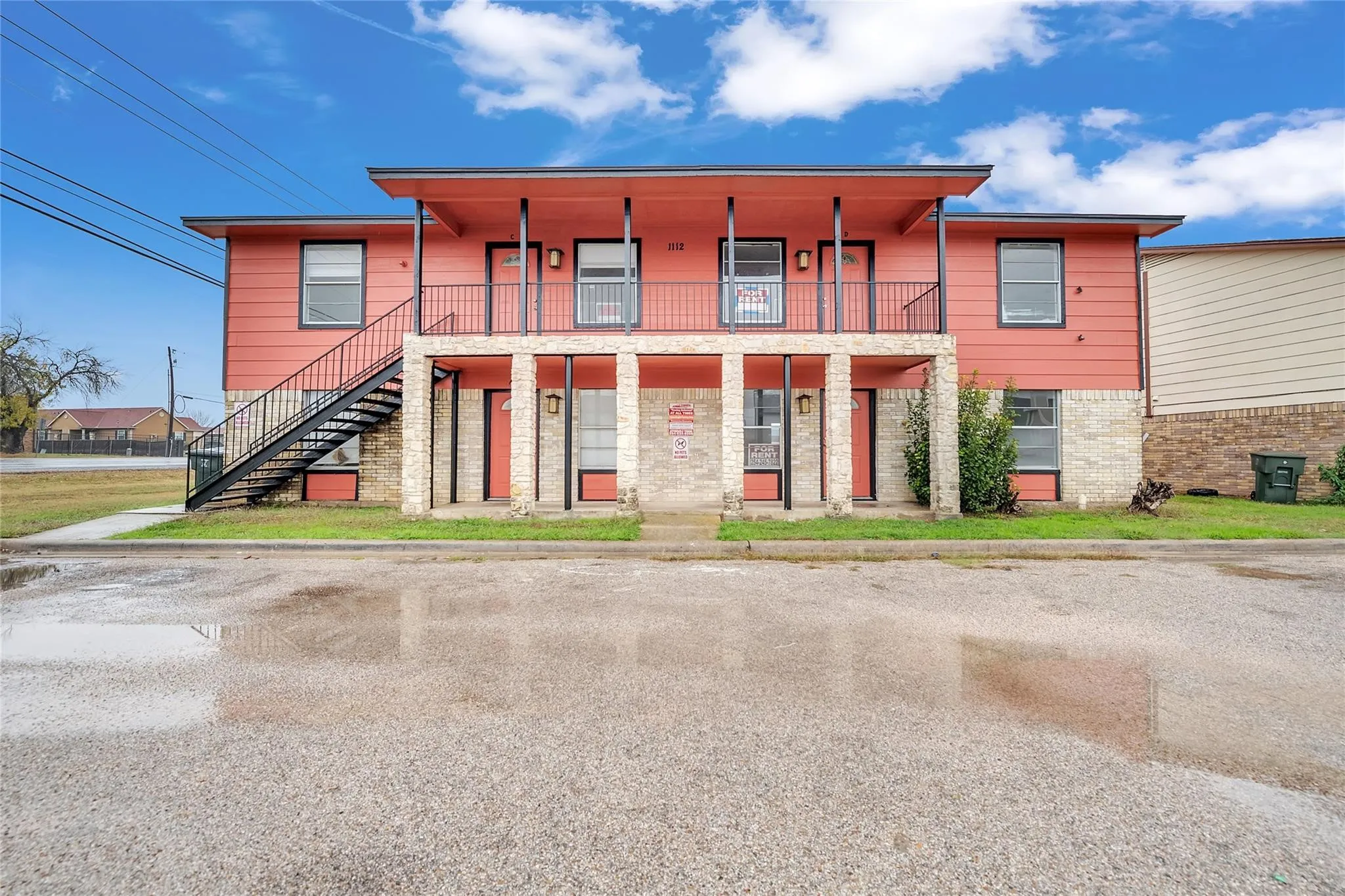 Two-story exterior with horizontal siding and stone accents