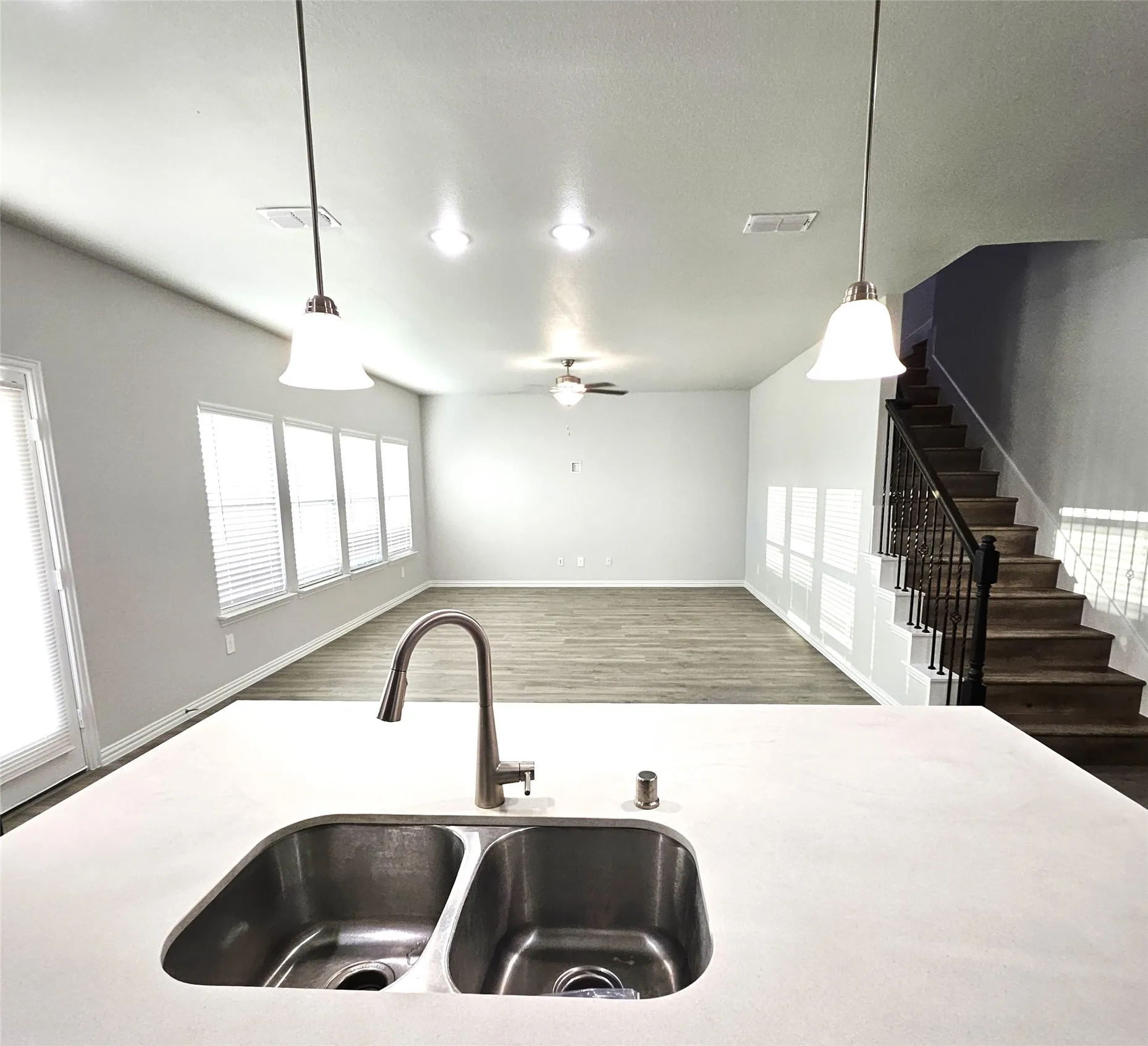 Kitchen island with a double basin stainless steel sink and gooseneck faucet