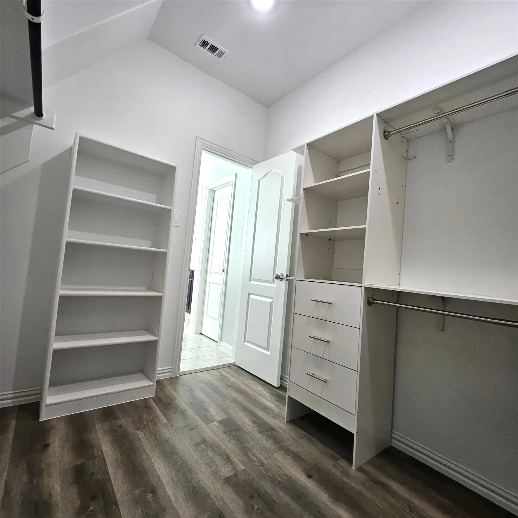 Integrated closet system with shelving, built-in drawers, and hanging rods