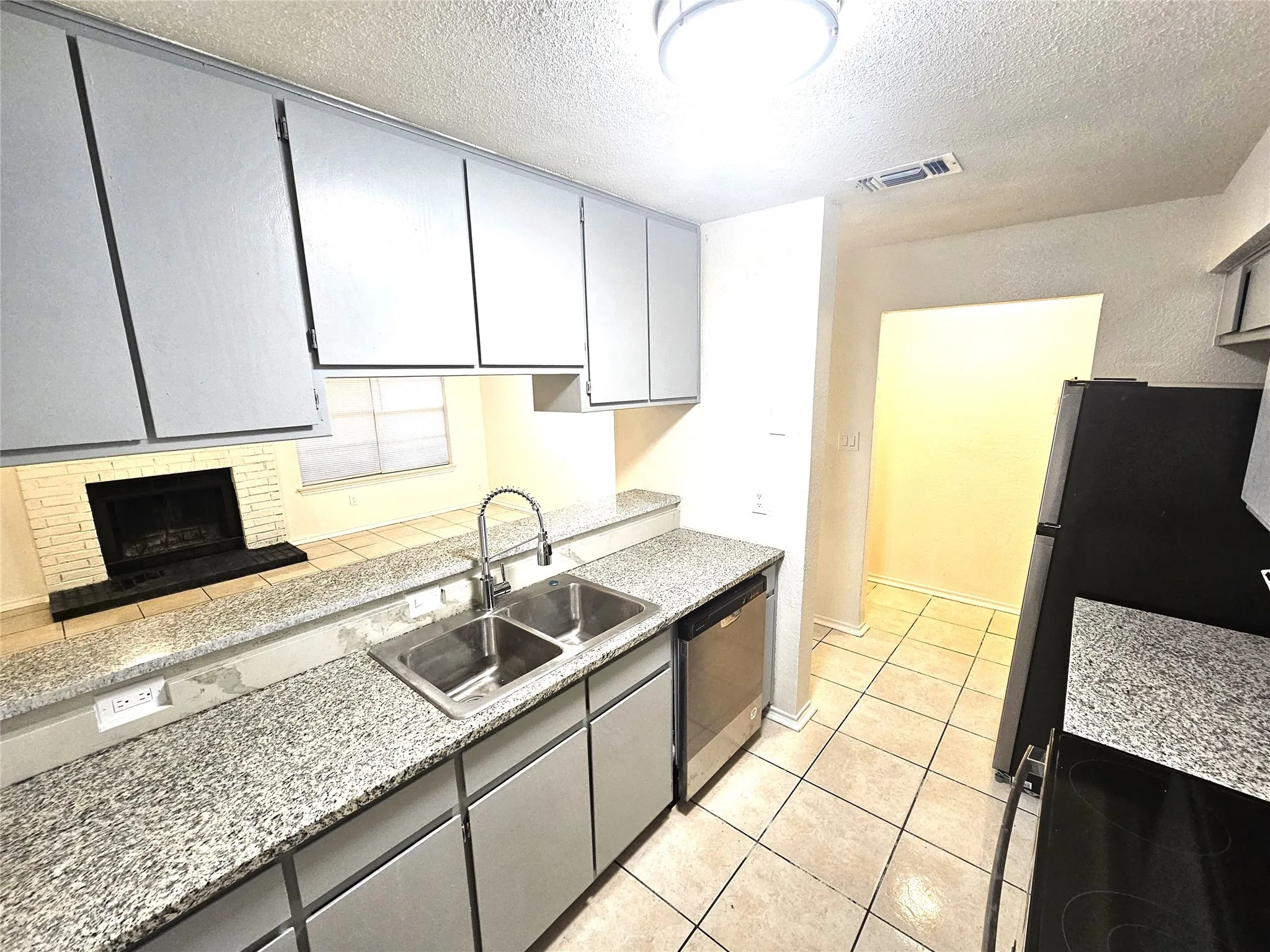Kitchen featuring new  stainless steel appliances, faucet, sink and granite countertops. (3425 Republic)