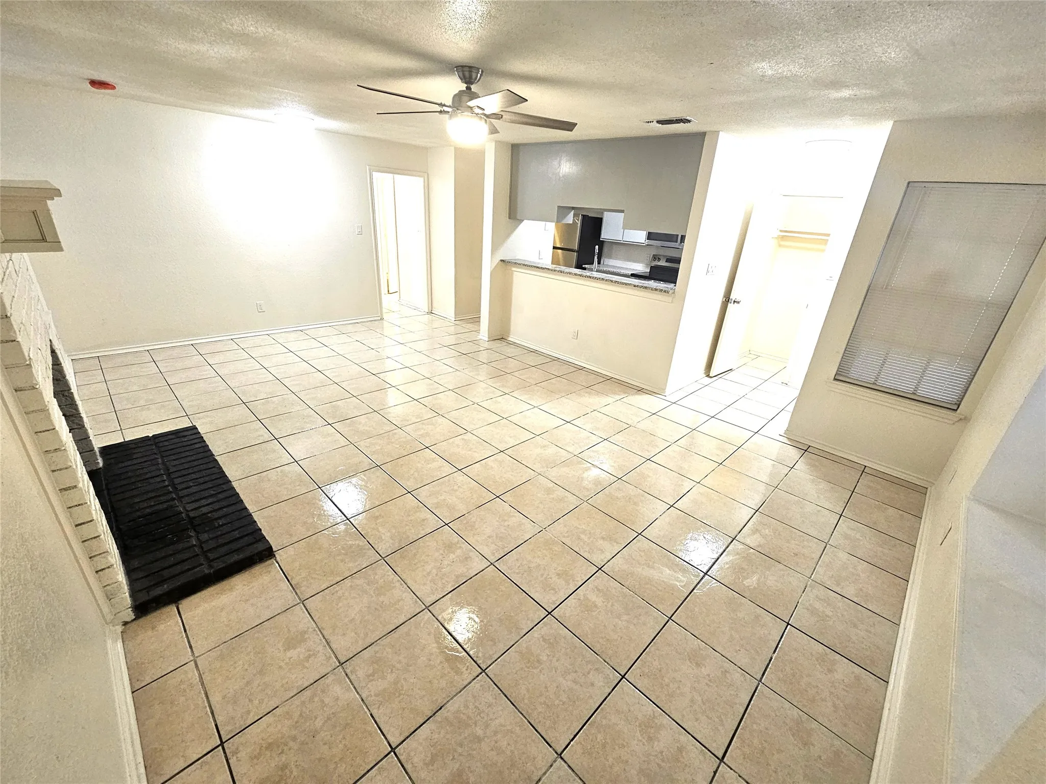 Big space living room with ceiling fan, fireplace. Open area to living and dining areas. (3425 Republic)