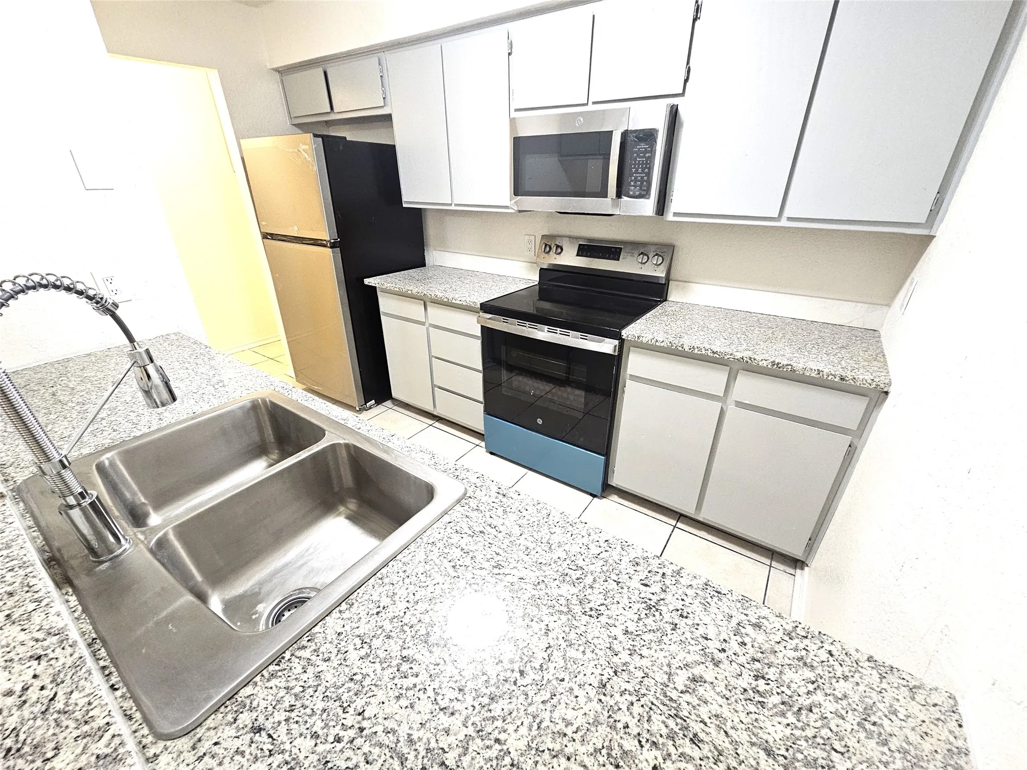 Kitchen featuring new  stainless steel appliances, faucet, sink and granite countertops. (3425 Republic)