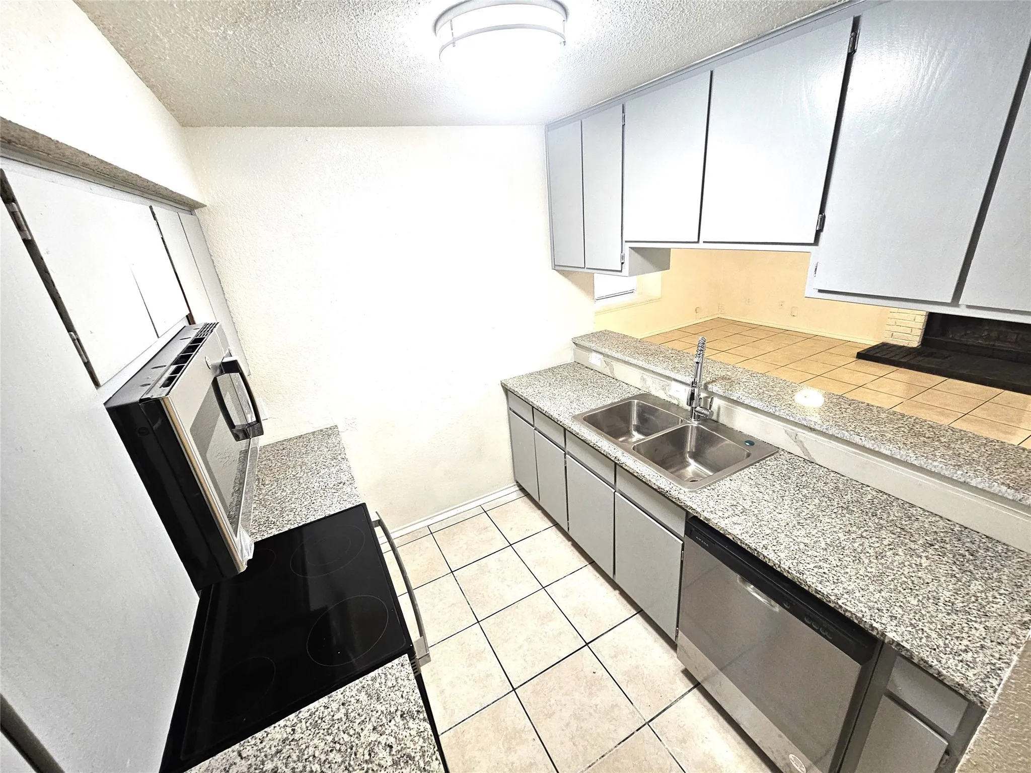 Kitchen featuring new  stainless steel appliances, faucet, sink and granite countertops. (3425 Republic)