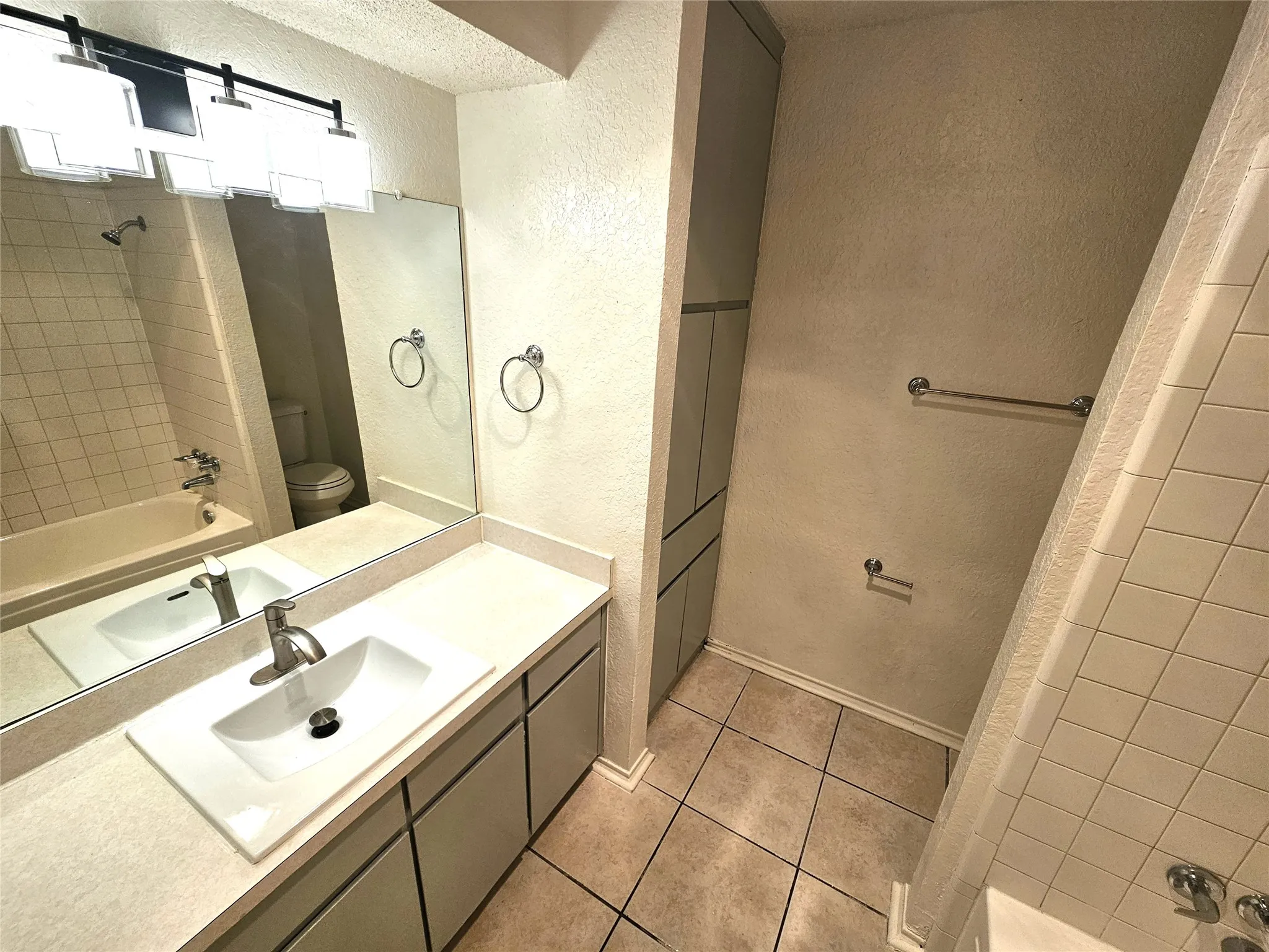 Full bathroom with vanity, tile patterned Full master bathroom (#1). (3425 Republic)
