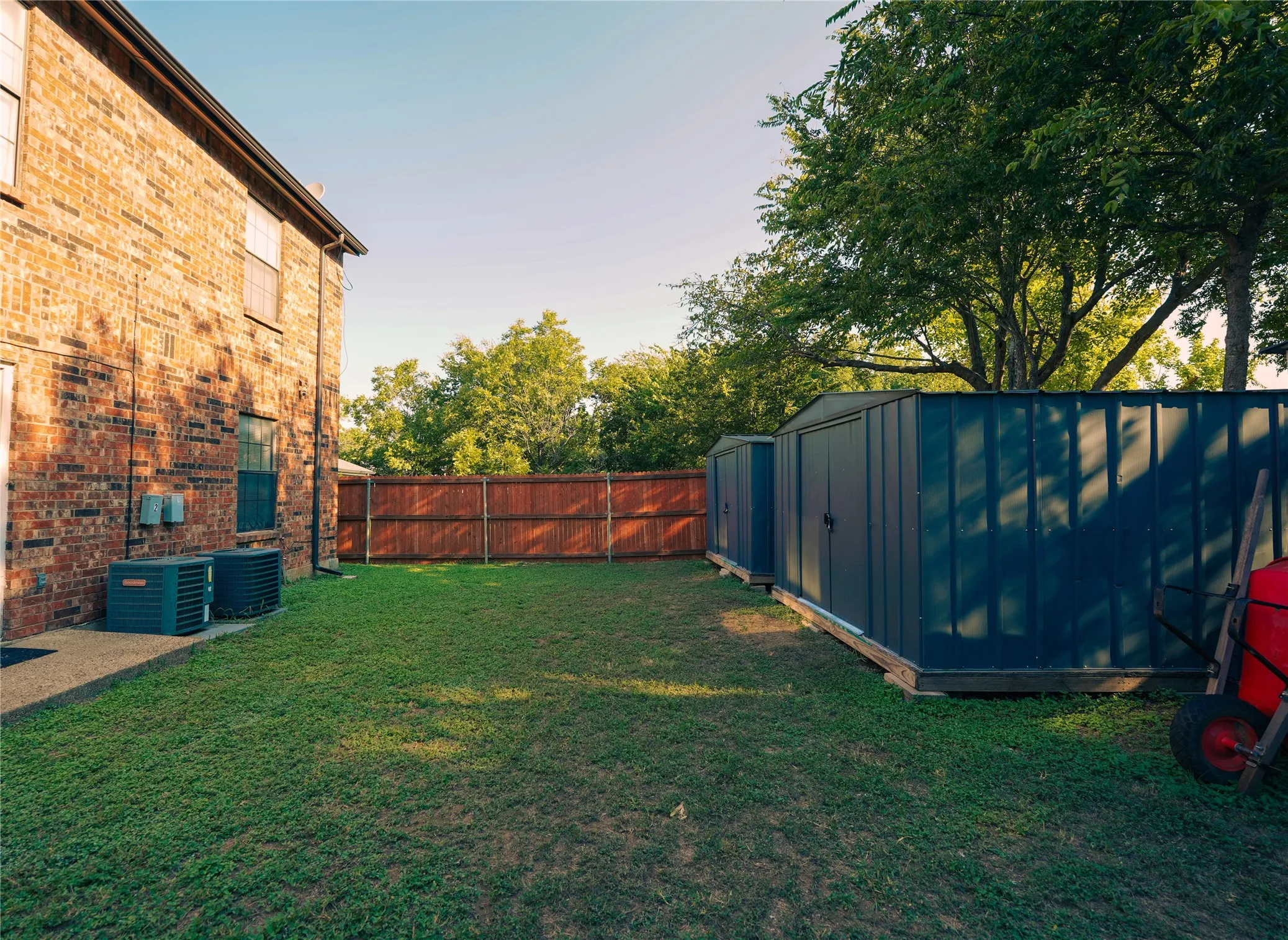 Fenced backyard featuring a shed
