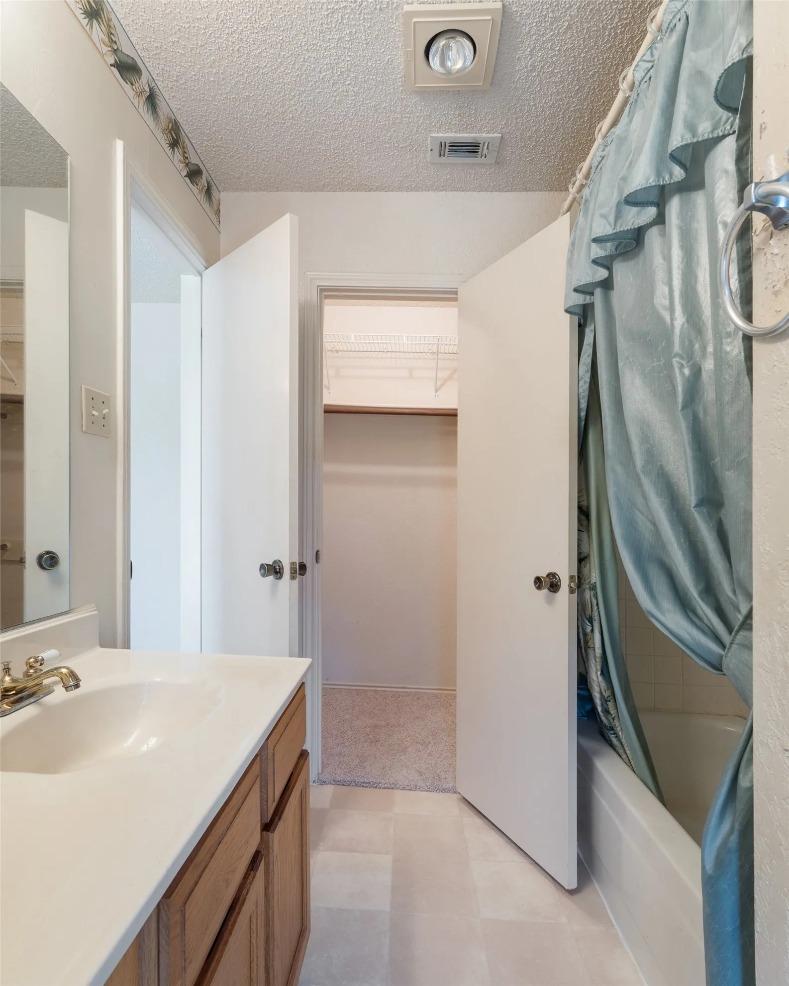 A walk-in closet is at the far end of the owners bathroom.