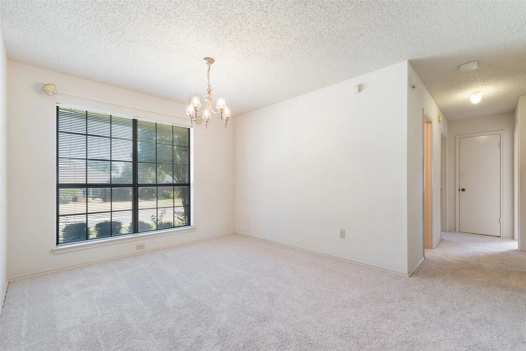 Looking from the dining room to the hallway leading to the bedrooms and baths.