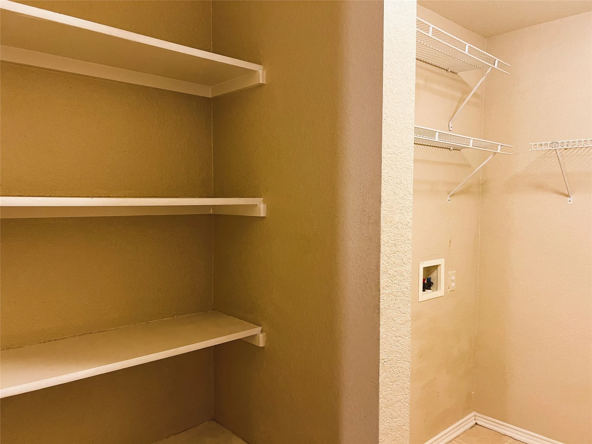 Shelving in utility room works well as a pantry.