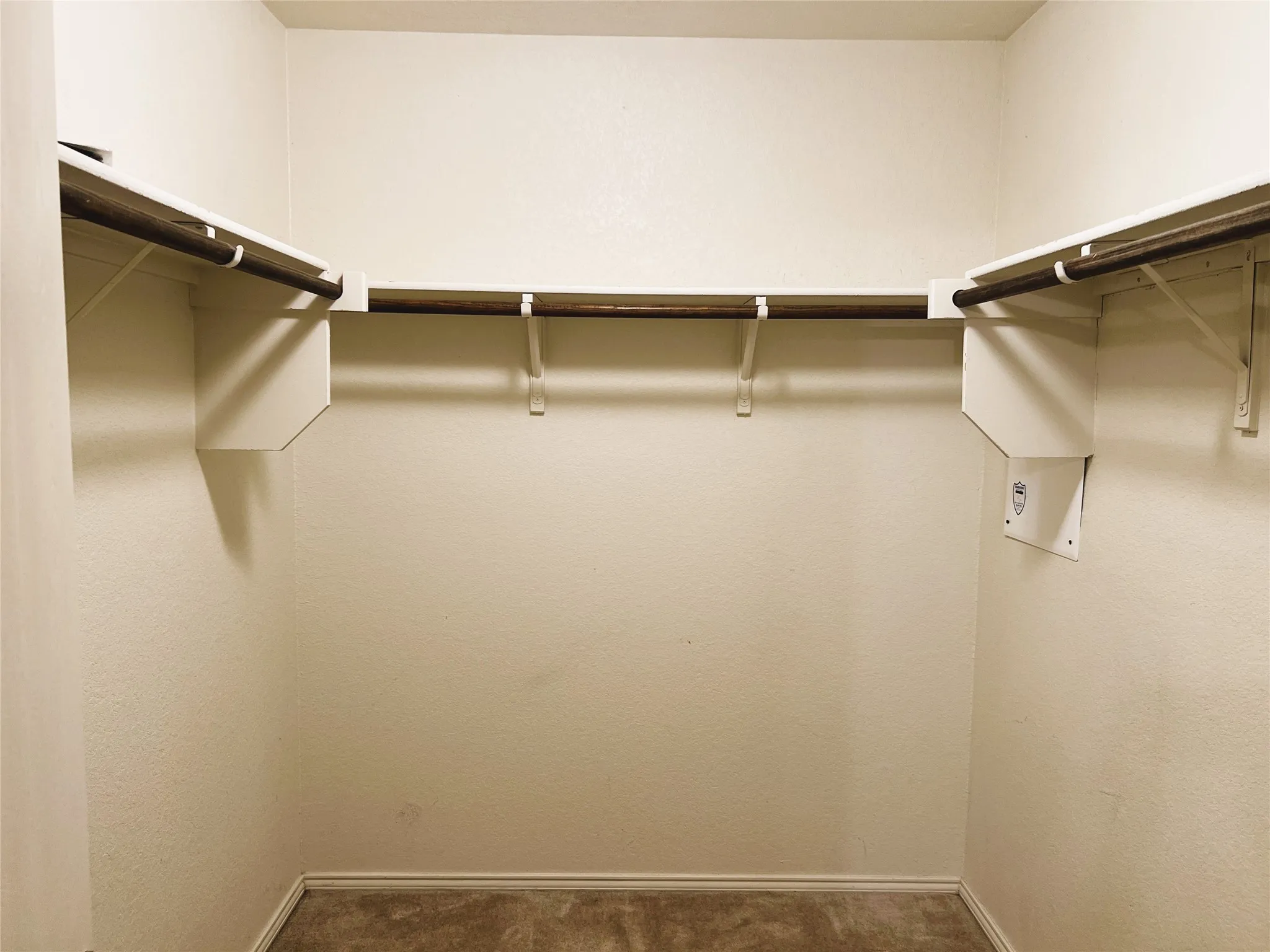 Walk in closet in primary bedroom.