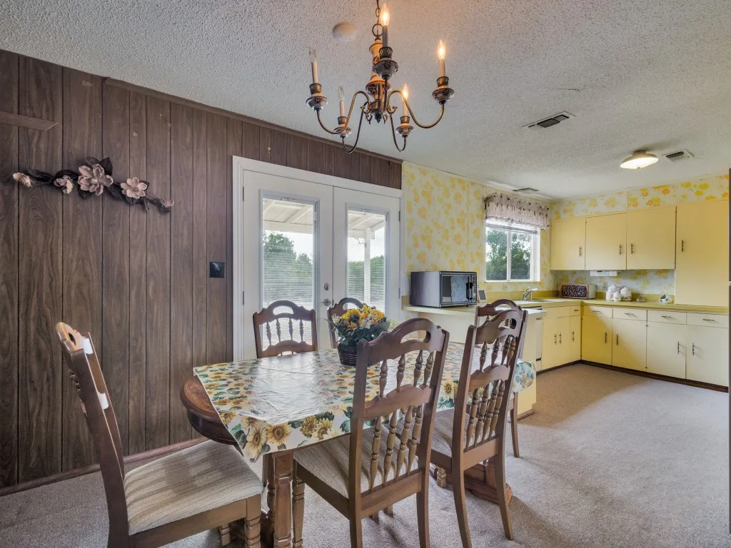 The layout of the open dining area and kitchen allows for easy traffic flow.  The French doors and kitchen window let in abundant light.