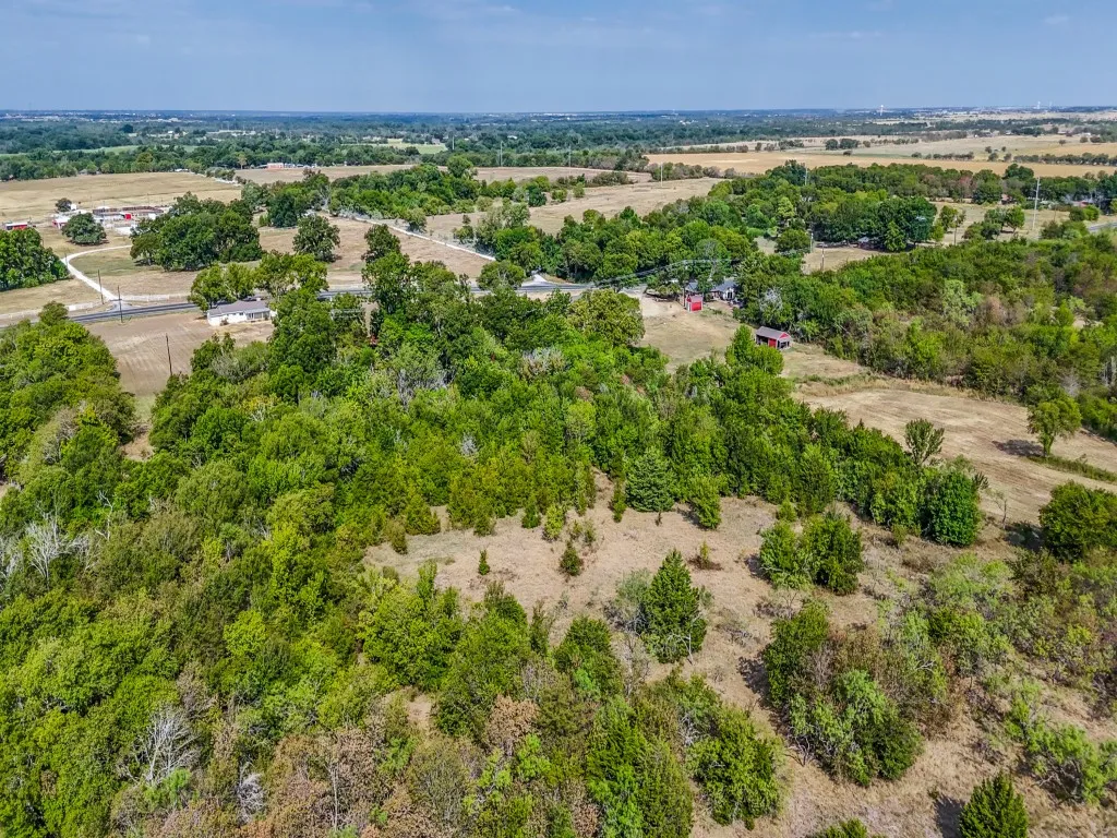 The home can be seen near the road.  The creek runs left to right through the middle of this photo.