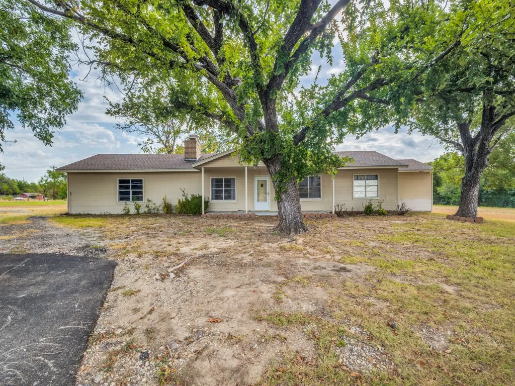 An oversized, two-car garage is on one end of the home with a circle drive on the side of the home providing extra parking and easy access to the roadway.