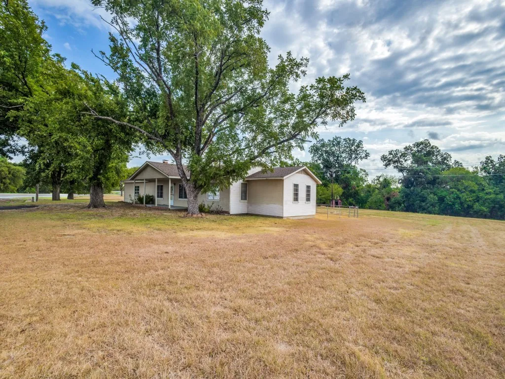 The home sits on a total of 8 acres.  A chain link fence encloses the backyard.