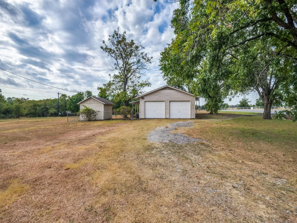 View of the garage side of the home with the circle driveway coming off of FM 2164.