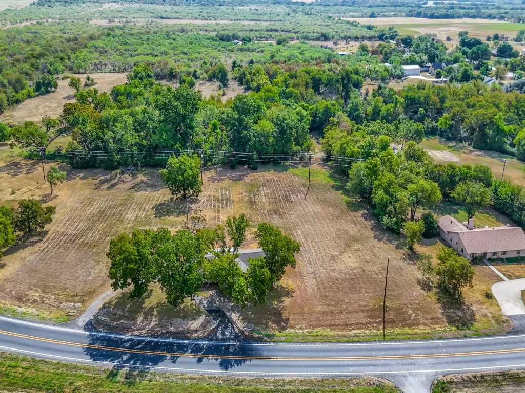 In this photo you can see the home with the circle drive.  The barn sits right in front of the treeline.  The 5-acre parcel begins around the treeline.