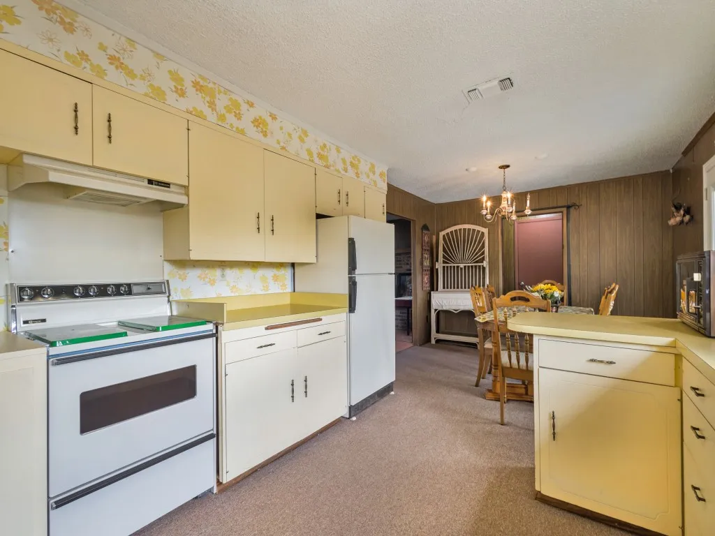 View from the kitchen into the dining area with the utility room and garage in the background.