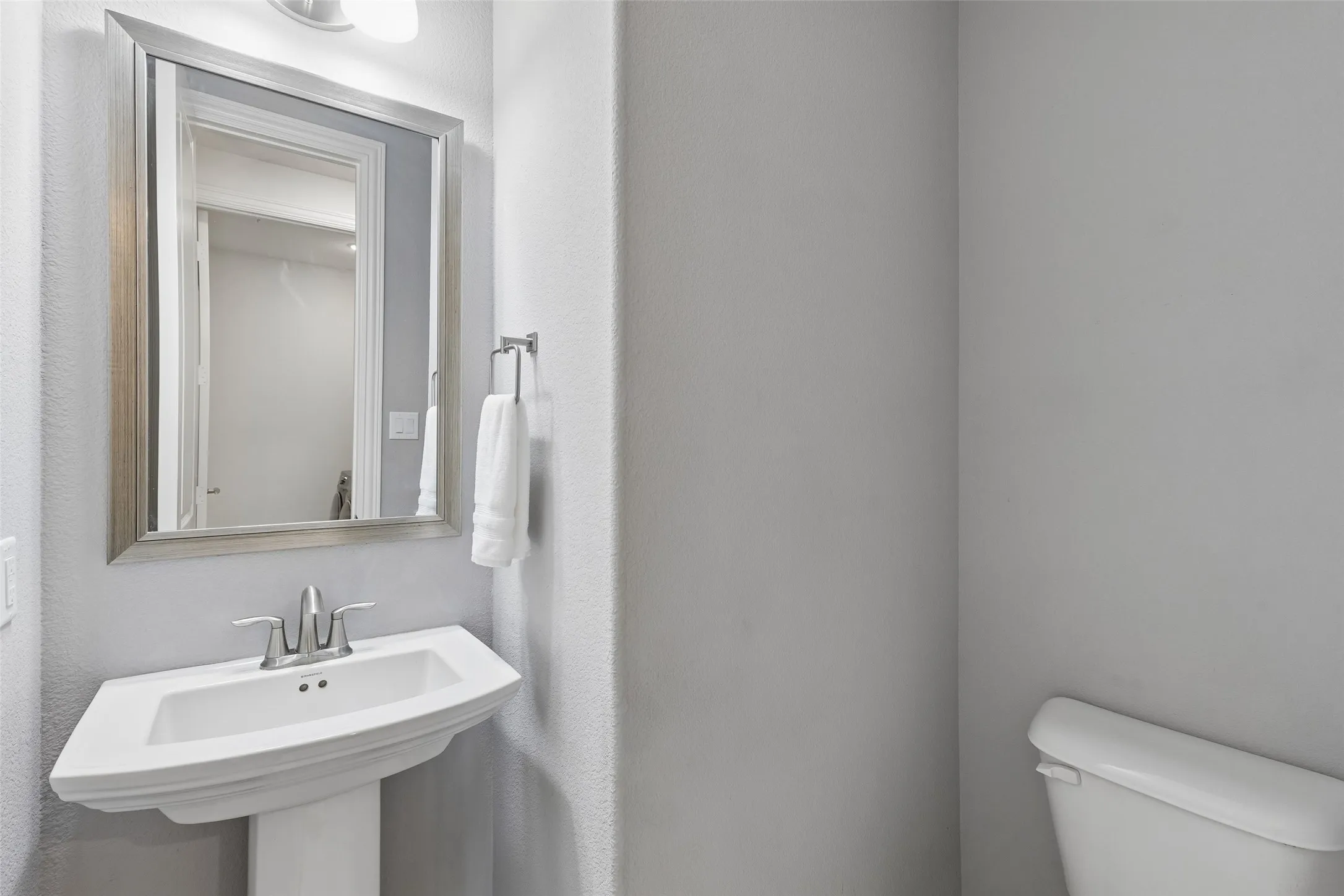 Guests have a powder bath of their own, keeping the private bedroom areas tucked away from the main living spaces.