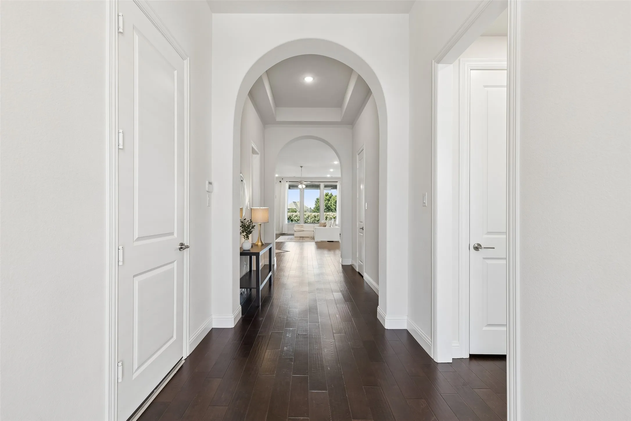 Step through the front door and follow the natural light toward the heart of the house, where the main living spaces begin to unfold.