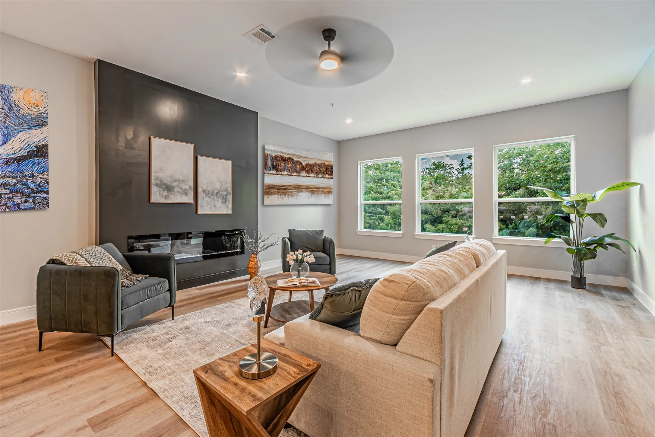 Very inviting electric fireplace. One of many Fire suppression sprinkler heads are hard to notice but straight in line of sight with the ceiling fan. No, not the recessed light.