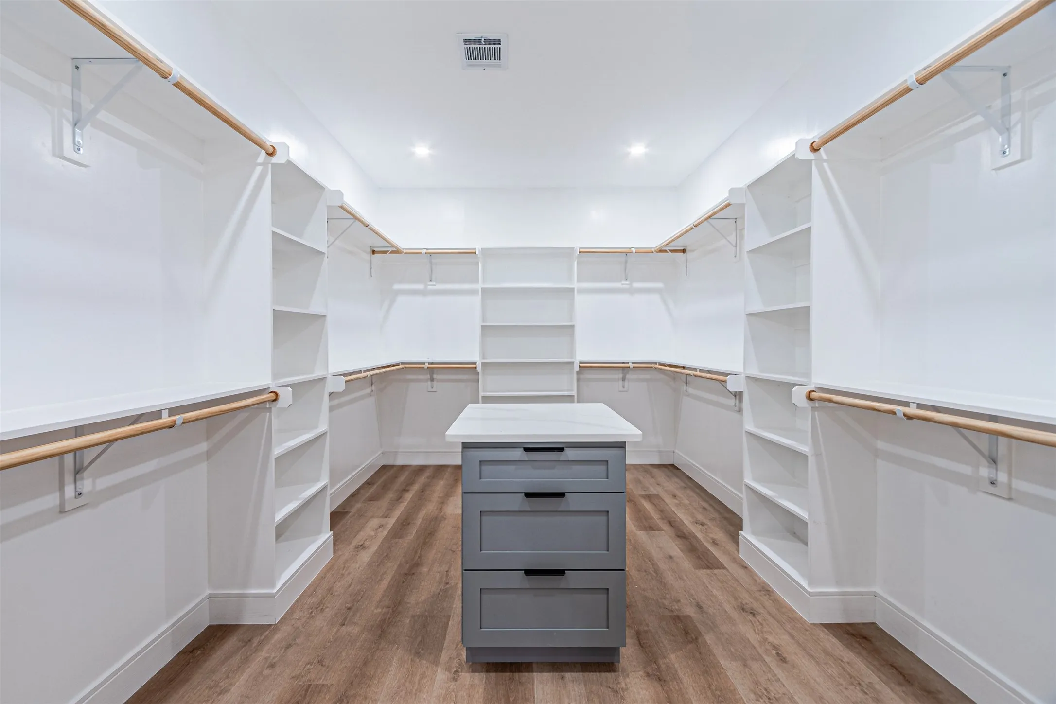 Master closet with built-in storage cabinet at middle