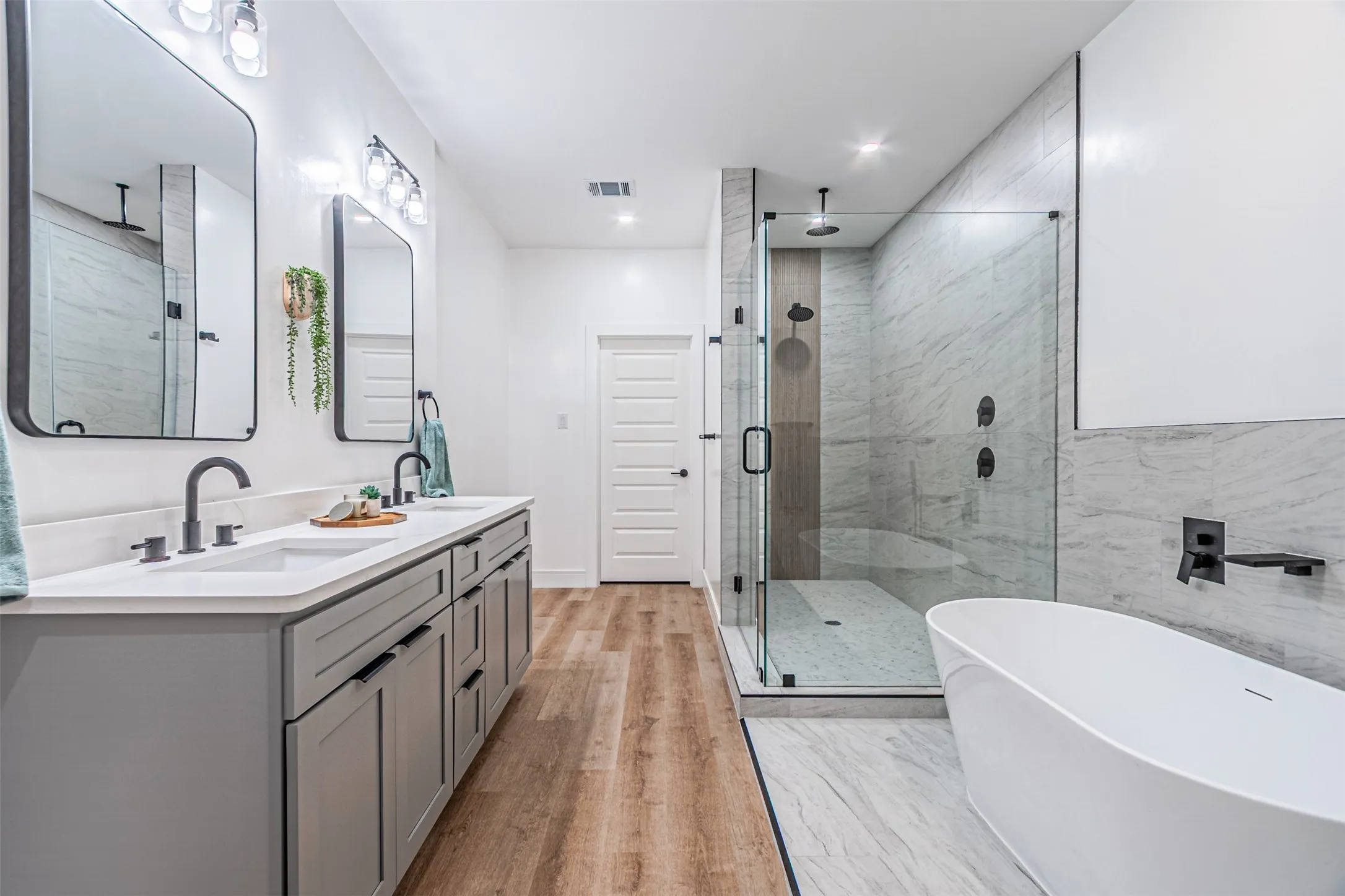 Main Suite has separate tub from the shower which has 2 heads with from the wall and another from overhead.