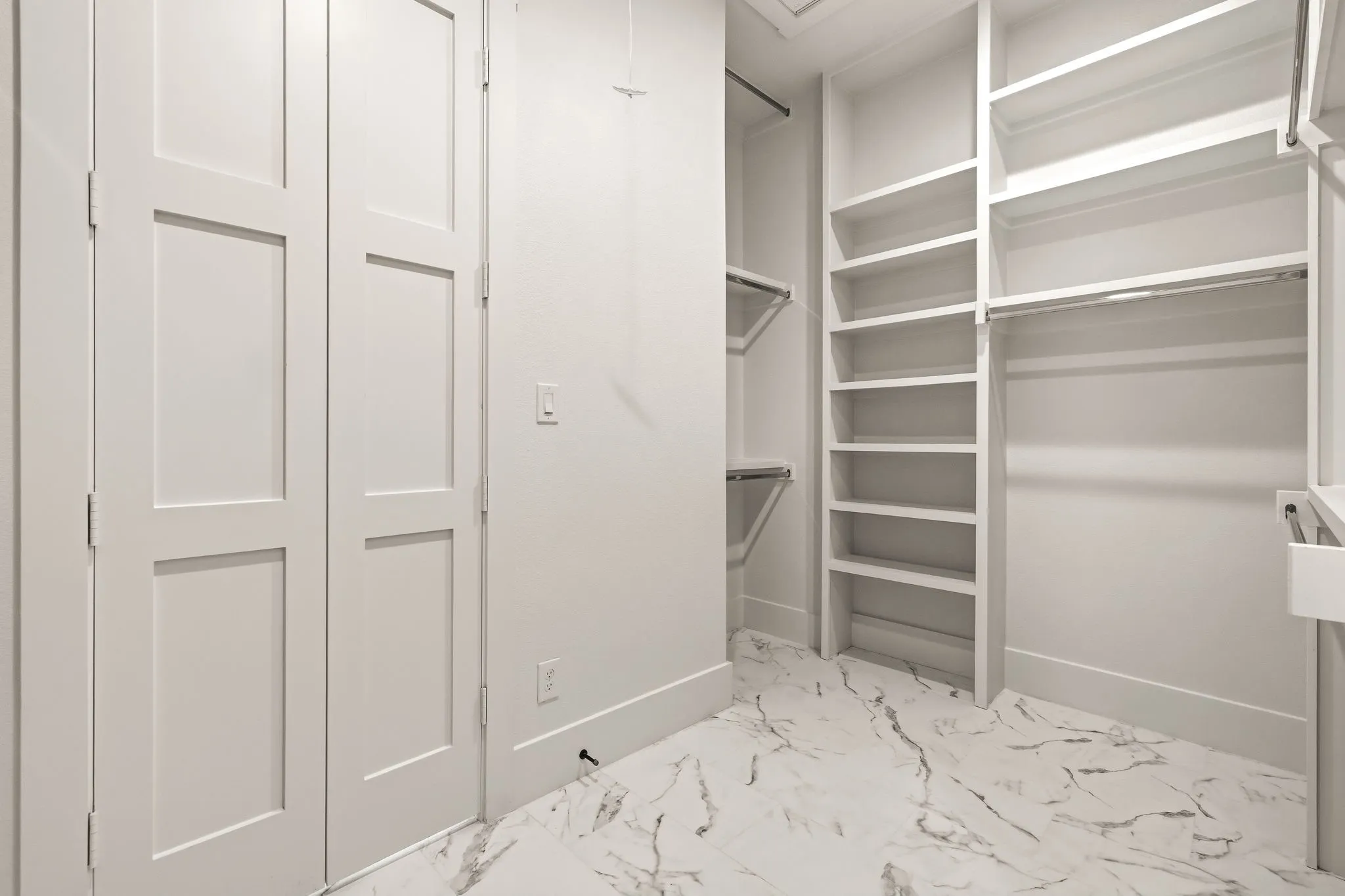 Oversized primary bedroom closet with direct access to laundry room