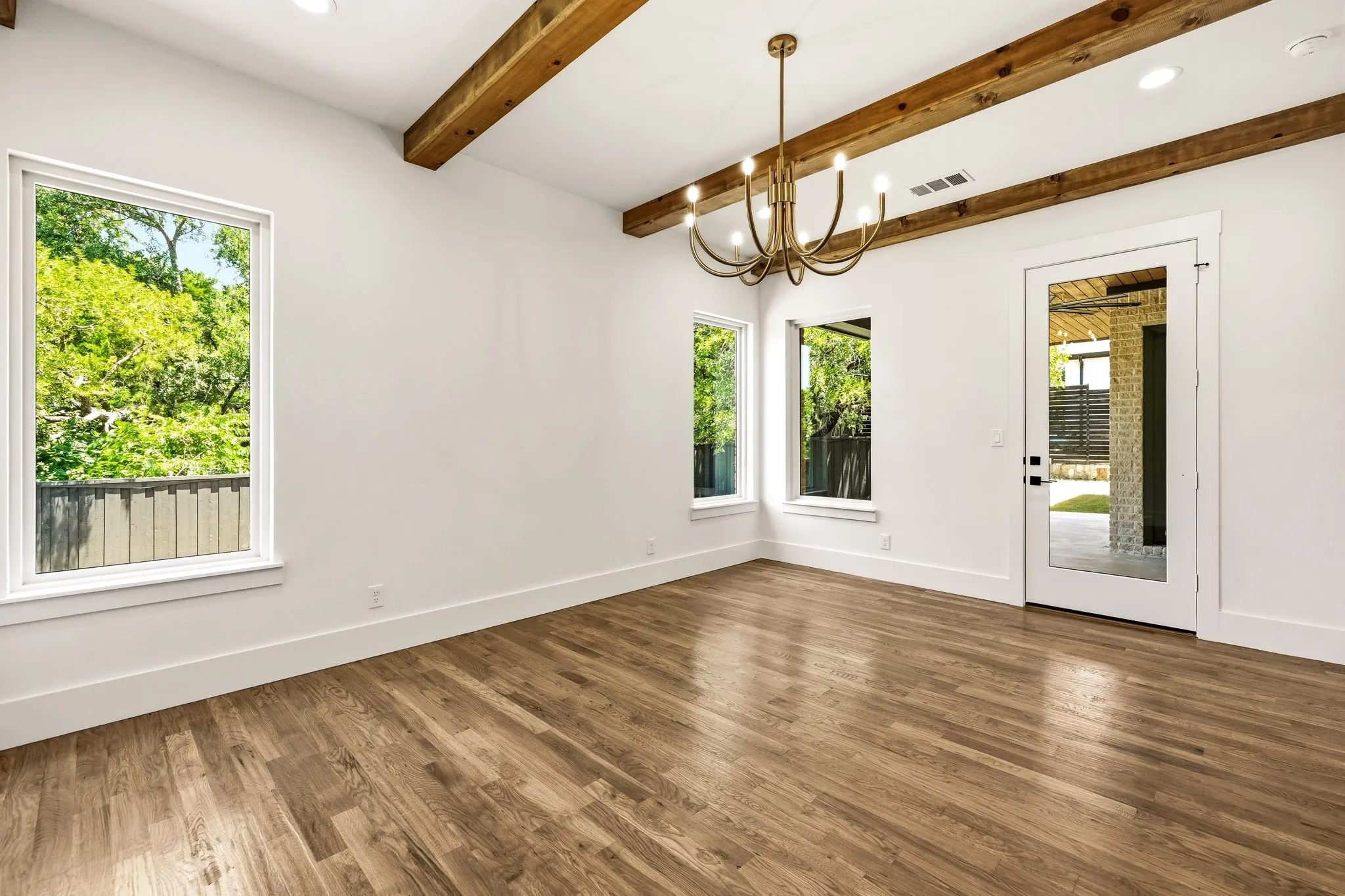 Wood beams, large windows and direct access to covered patio