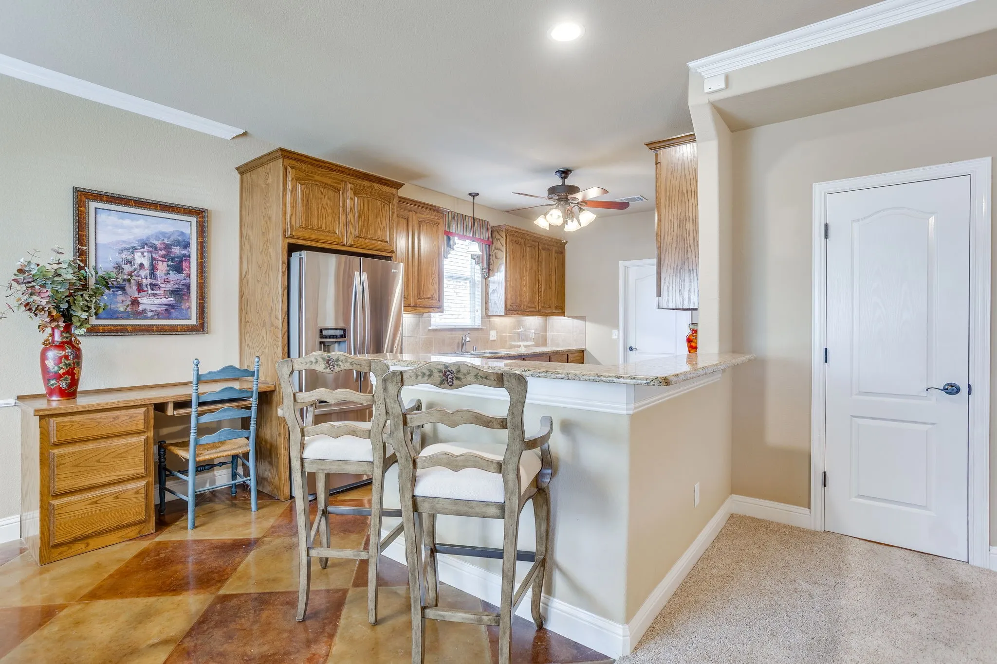 Bartop seating overlooking the kitchen and living. Built in desk for home organization.