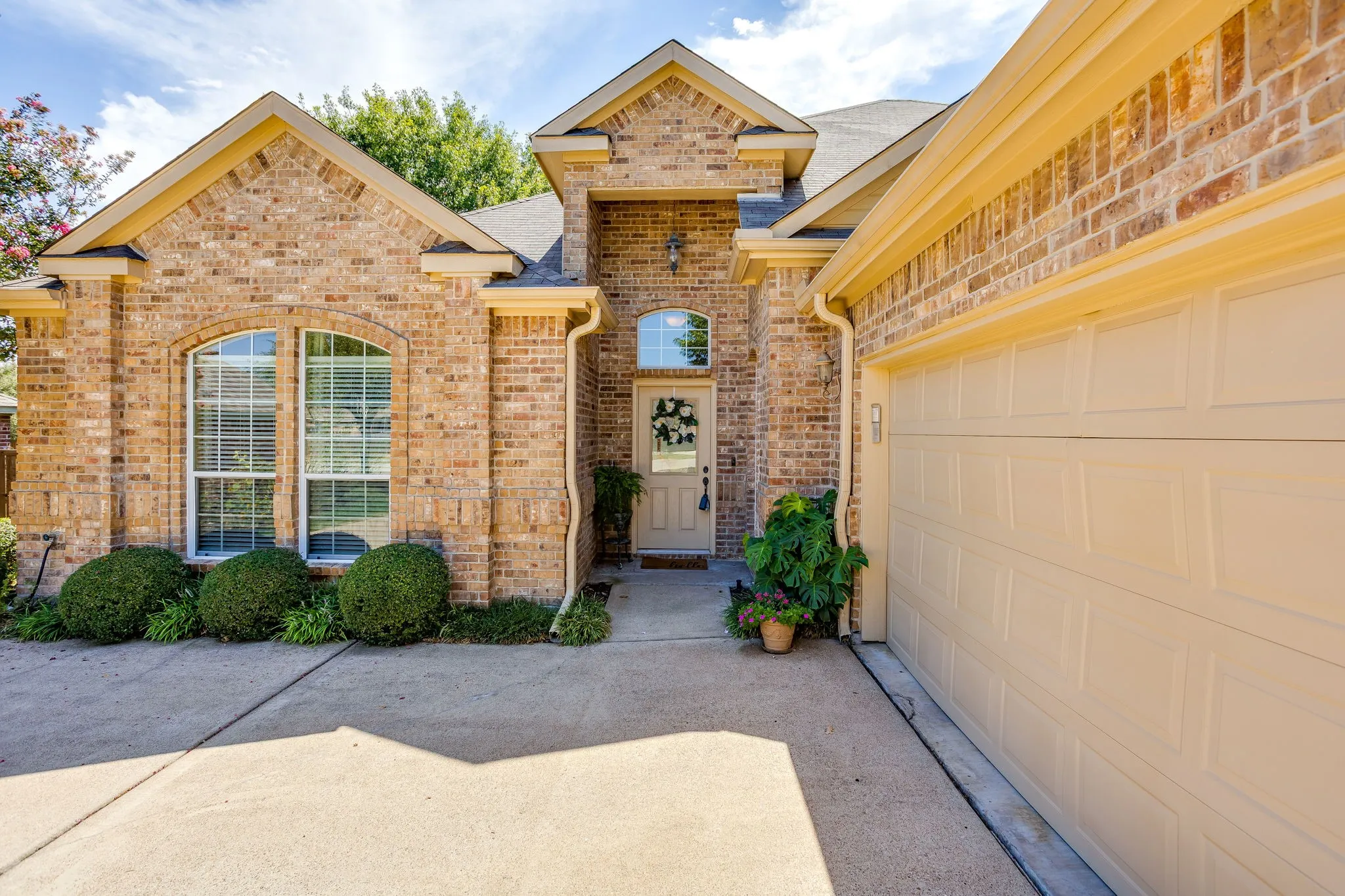 Fully bricked home with side swing driveway, rain gutters and  2 car garage.
