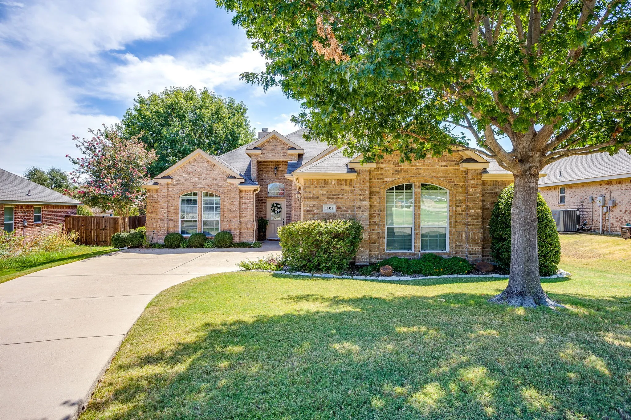 Lush landscaping and mature trees.