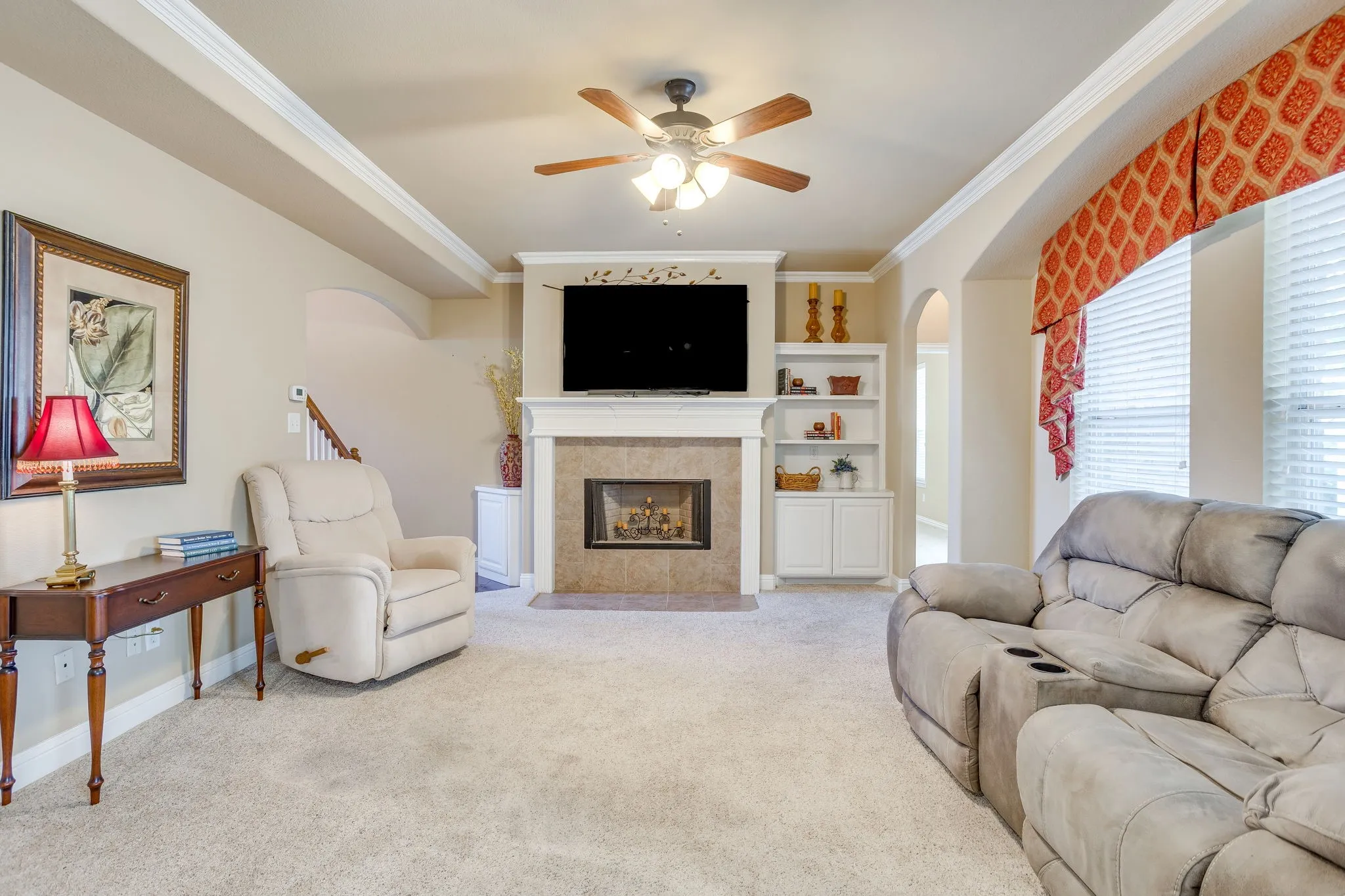 Wood burning fireplace with adjacent built ins for storage and decor.