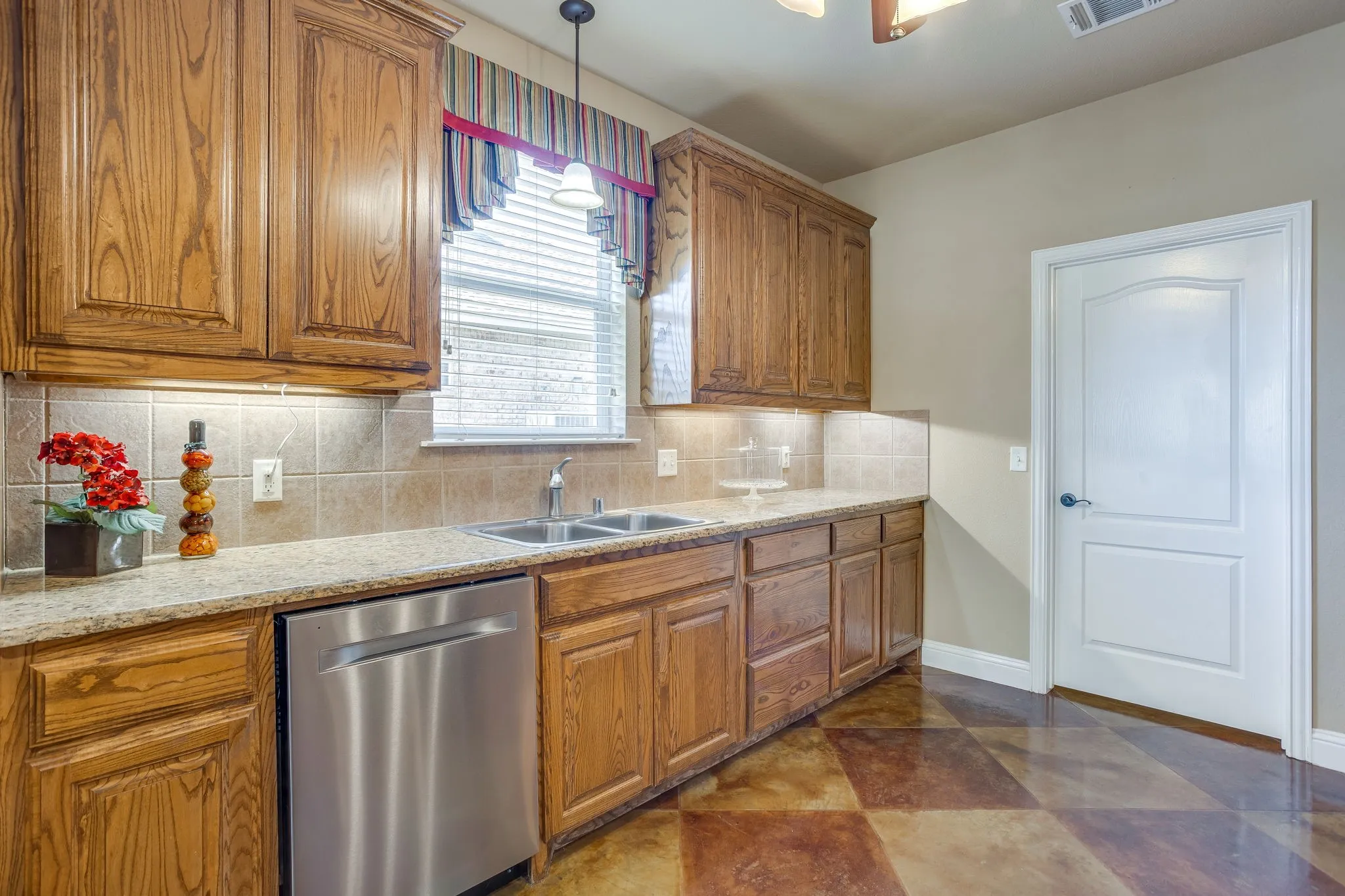 Stainless steel dishwasher, access to laundry room and nice sized pantry.