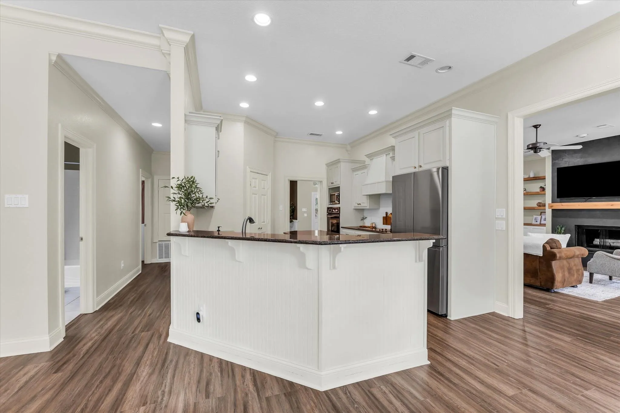 Kitchen island with a dark countertop and white beadboard paneling