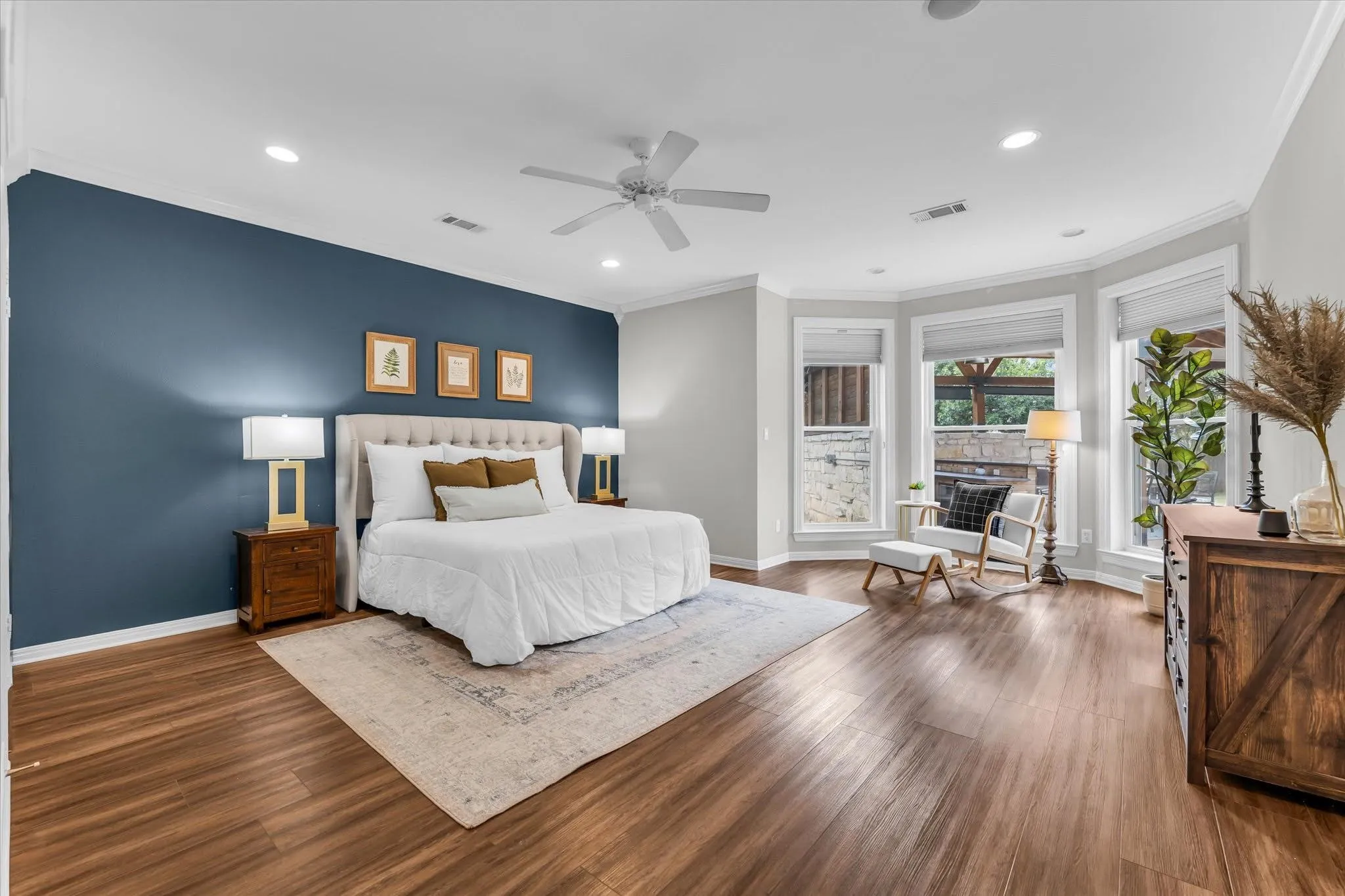 Wood-finish flooring, recessed lighting, ceiling fan, and bay windows