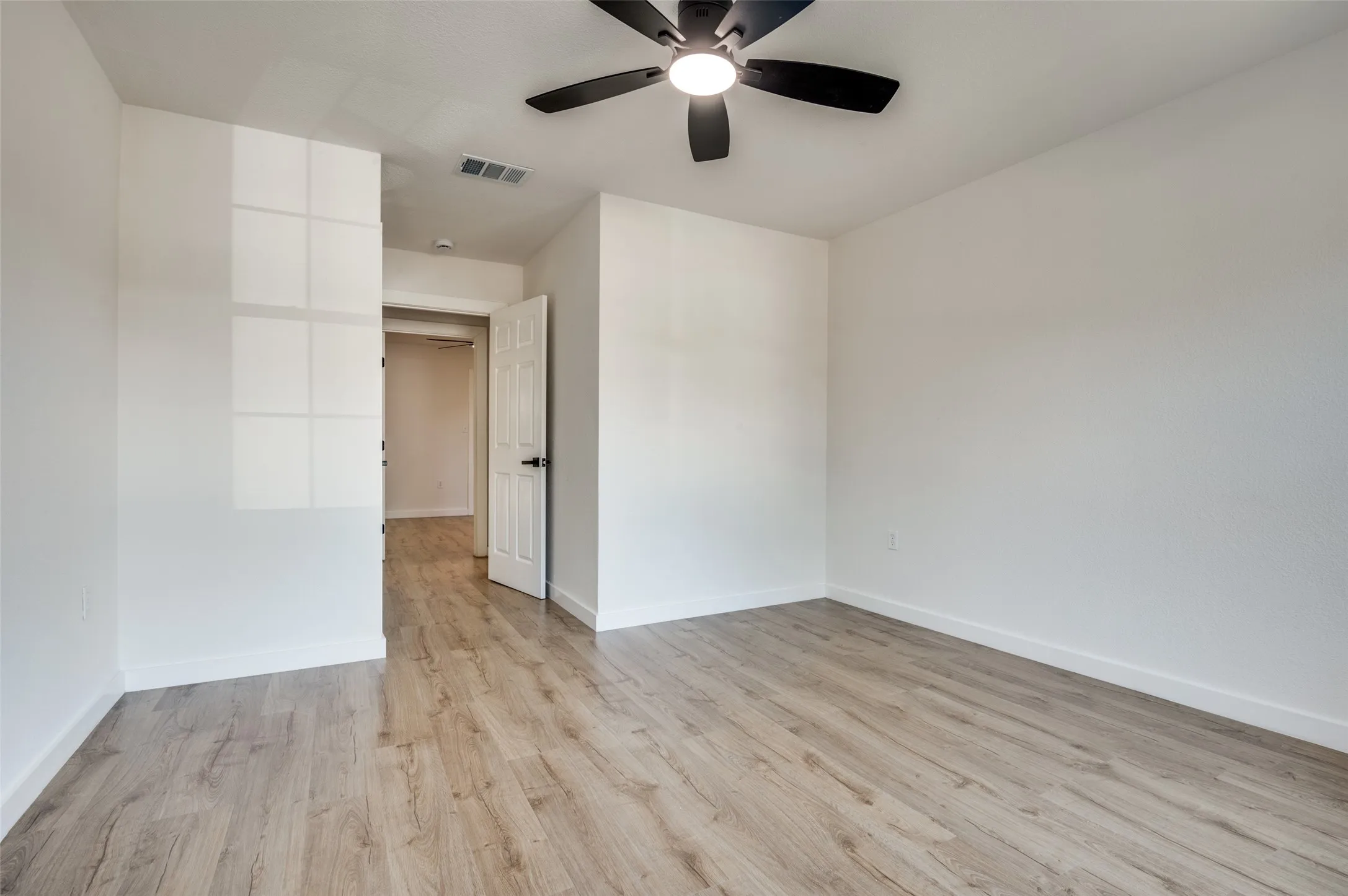 Spare room with light wood-style floors and ceiling fan