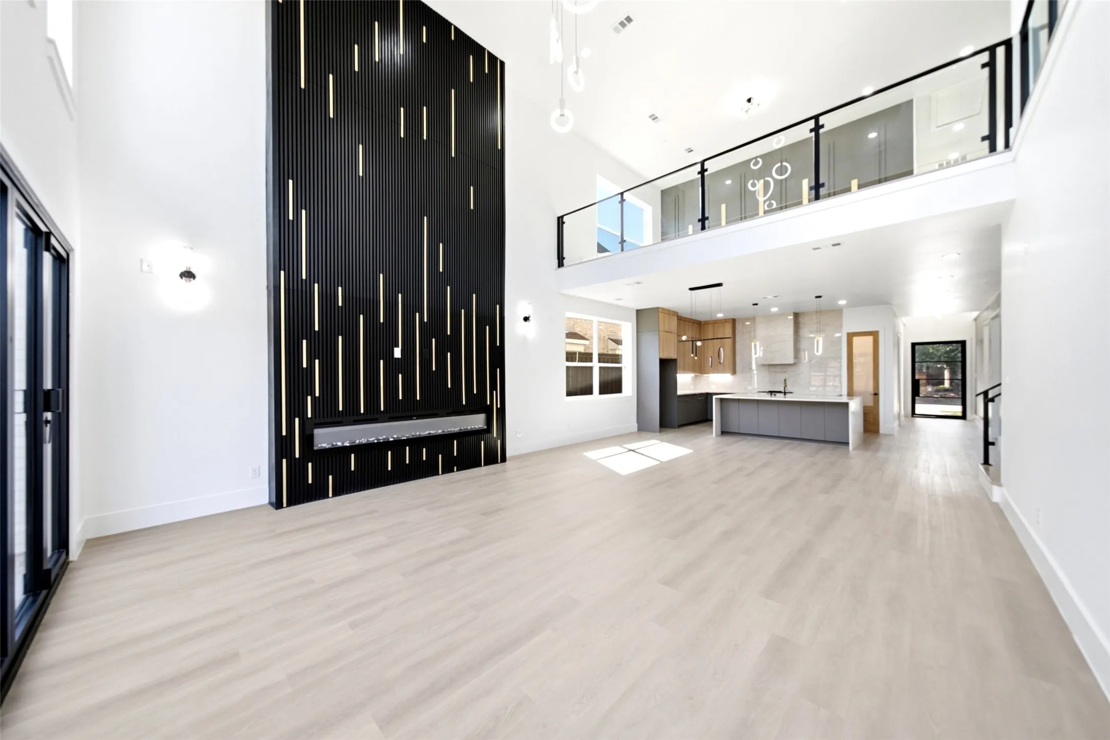 Expansive living area featuring soaring ceilings and light wood-finish flooring