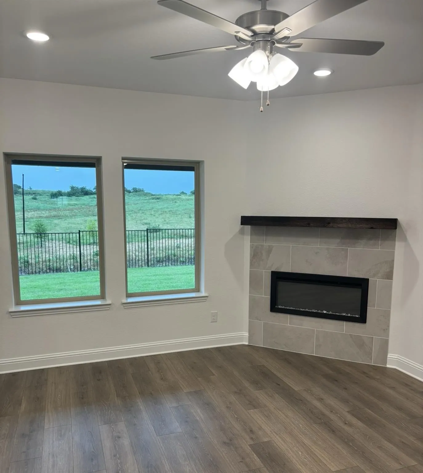 Electric fireplace with a tile surround and wood-finish mantel