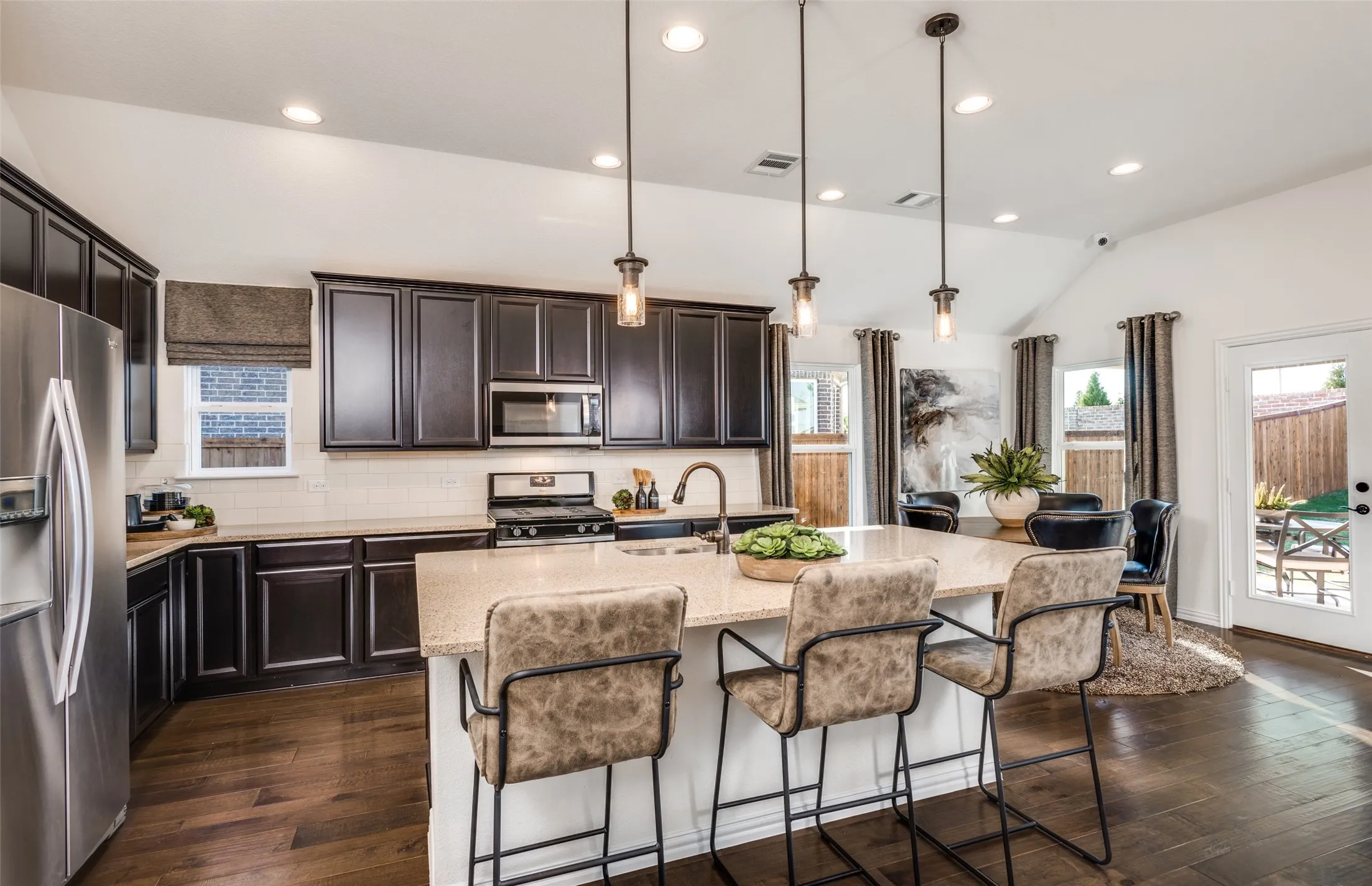 *Model Representation - Large island overlooking gathering room and dining areas