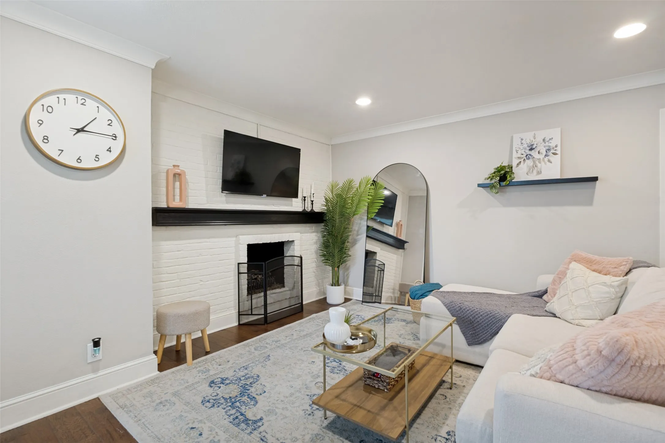 Painted brick fireplace with a dark wood mantel