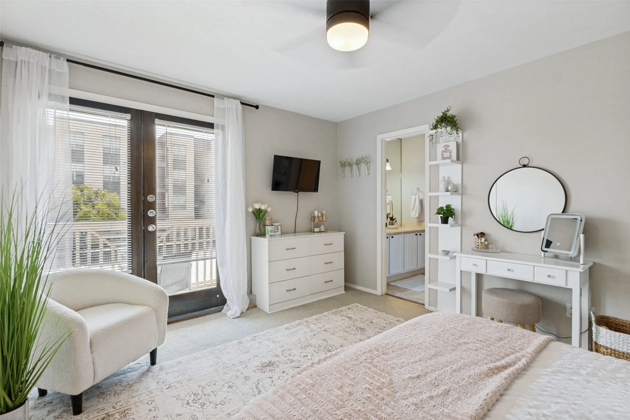 Hardwood-finish flooring, ceiling fan with integrated lighting, and a glass-paneled exterior door
