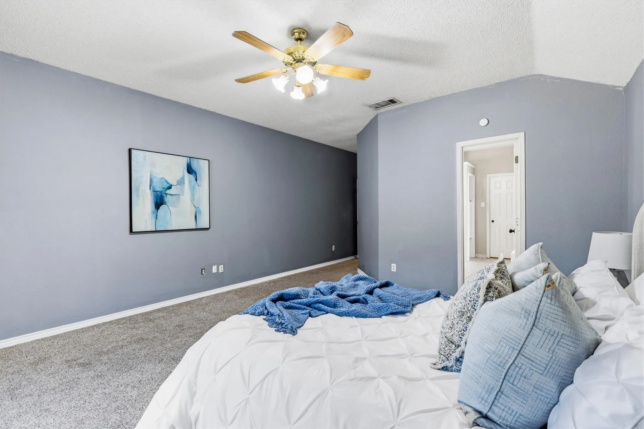 Carpeted flooring, vaulted ceiling, and ceiling fan with integrated lighting
