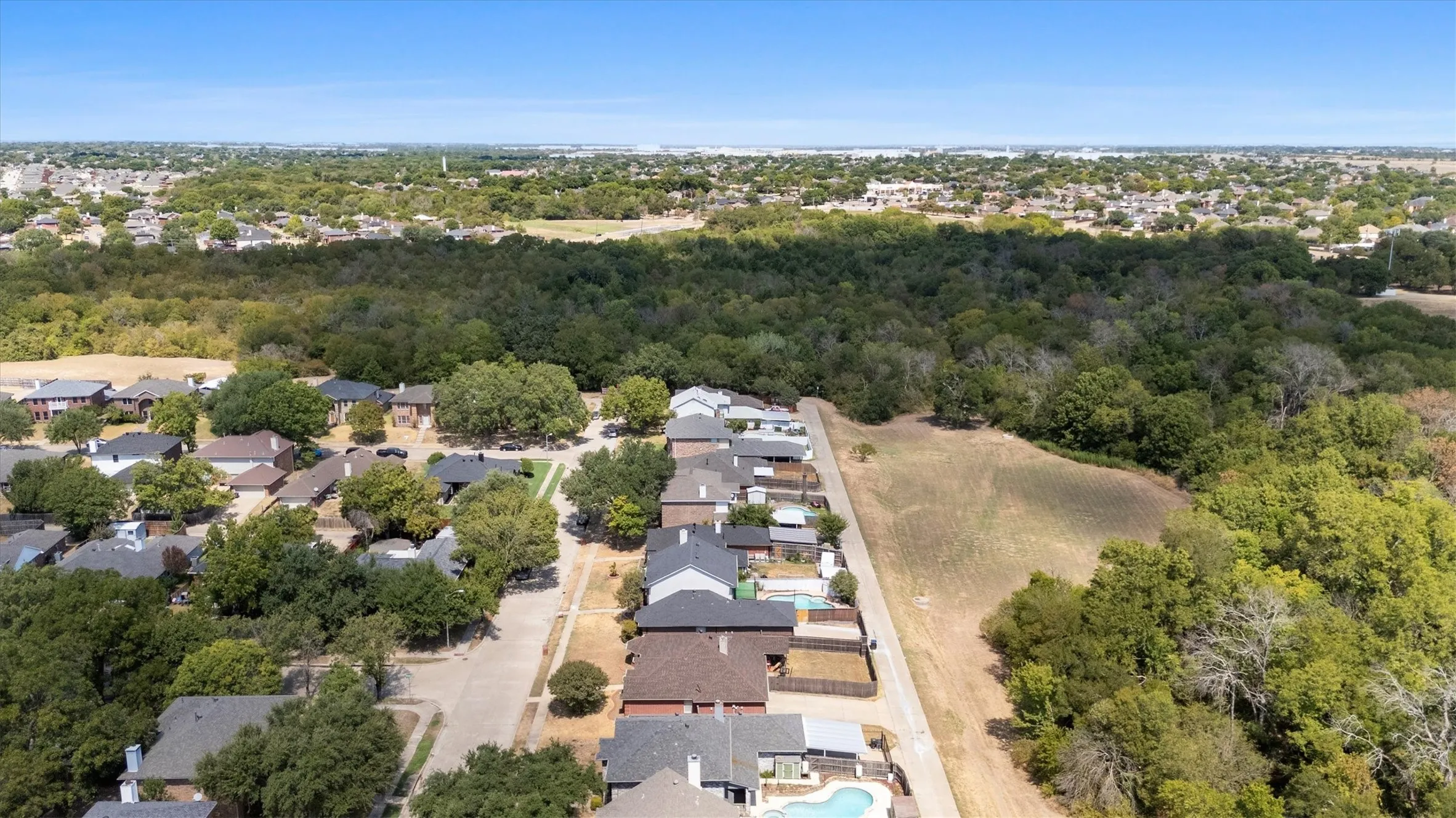 Neighborhood setting with mature trees and established residences