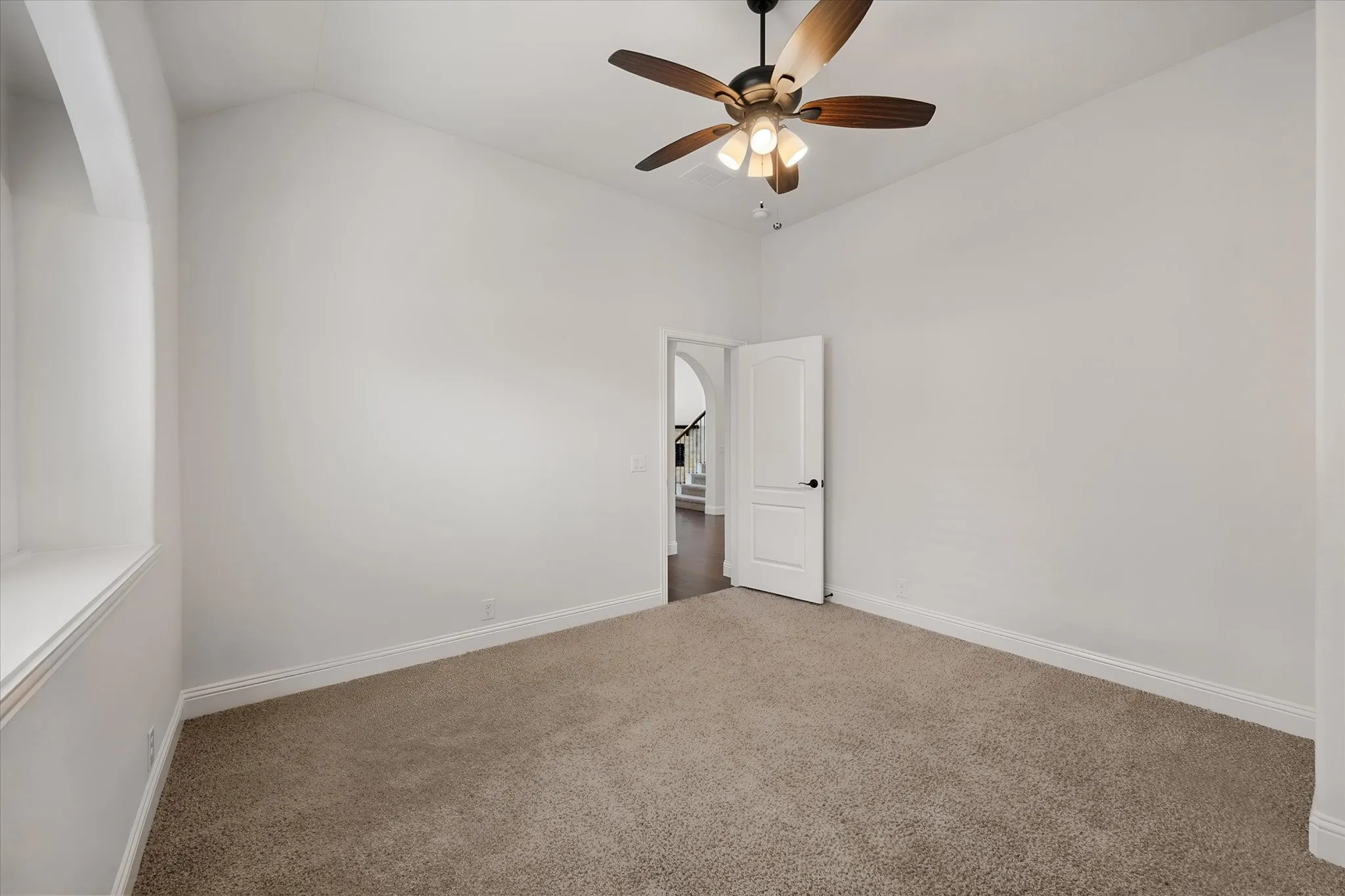 Same room, just turning around so you can see — it opens right out to the hallway, and that ceiling height really lets the light bounce around in here.
